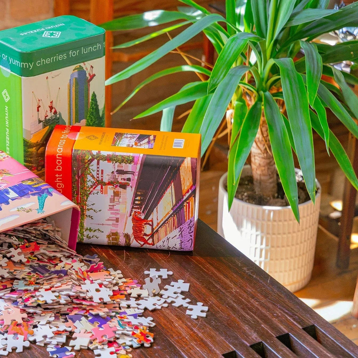 Unique puzzles for adults from the Niyuki 500-piece collection, boxes stacked — by Chive Studio