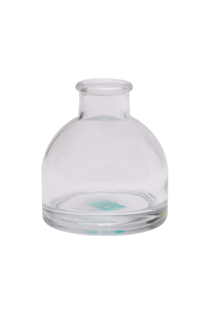 Chive Loft round glass bud vase in clear glass with a domed silhouette and short neck.