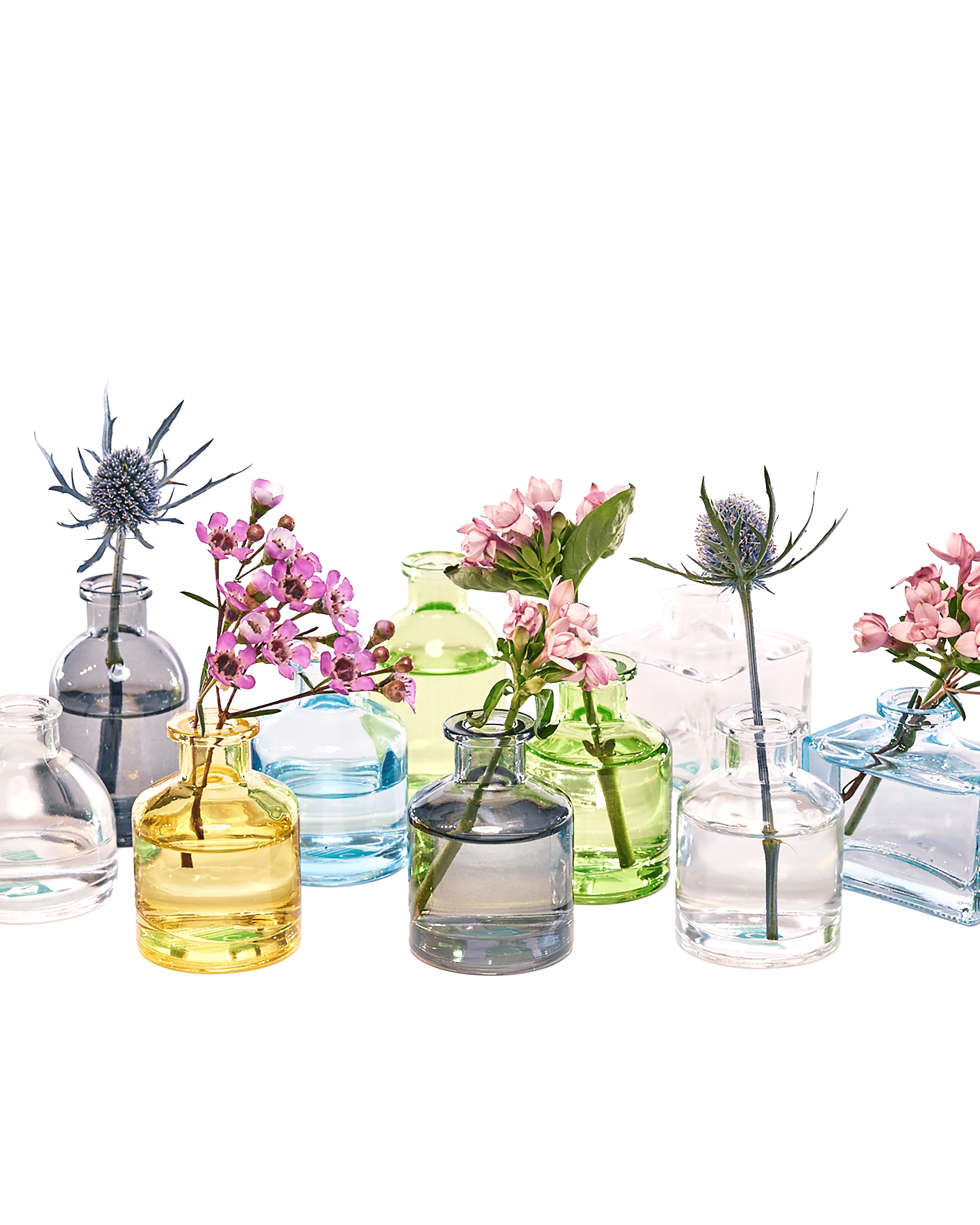 Chive Loft glass bud vase collection mixes clear, amber, sage, and blue jars in round and square shapes.