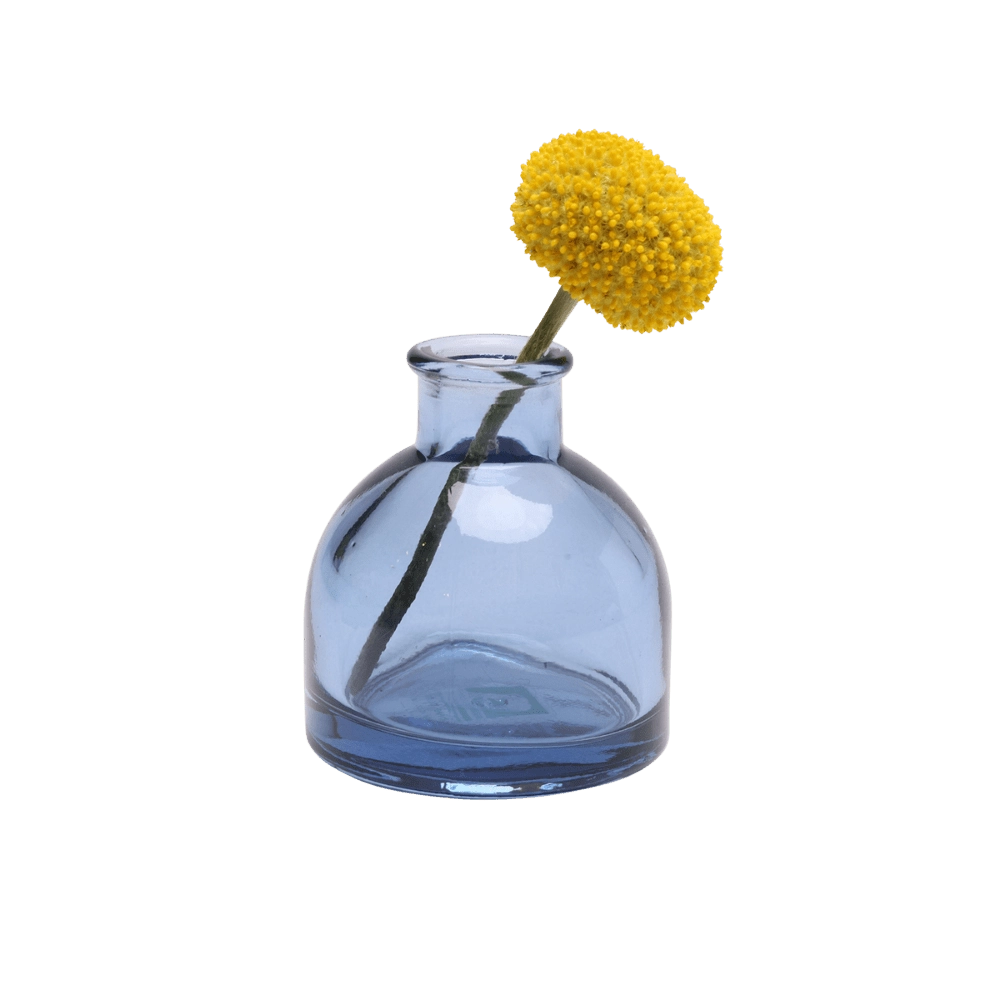 Chive Loft round glass bud vase in medium blue styled with a single yellow billy ball bloom.