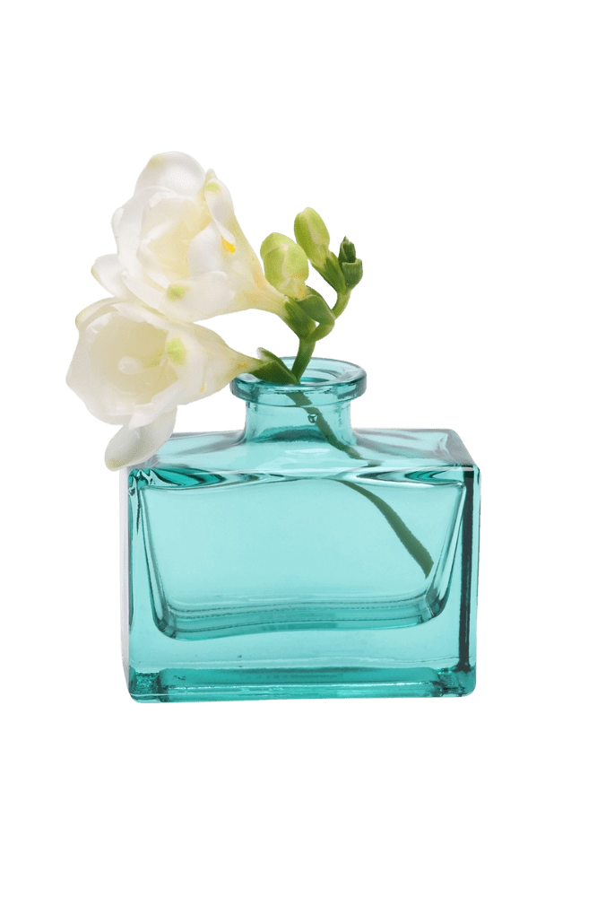 Chive Loft glass bud vase in Teal holds white freesia blooms with trailing green buds.