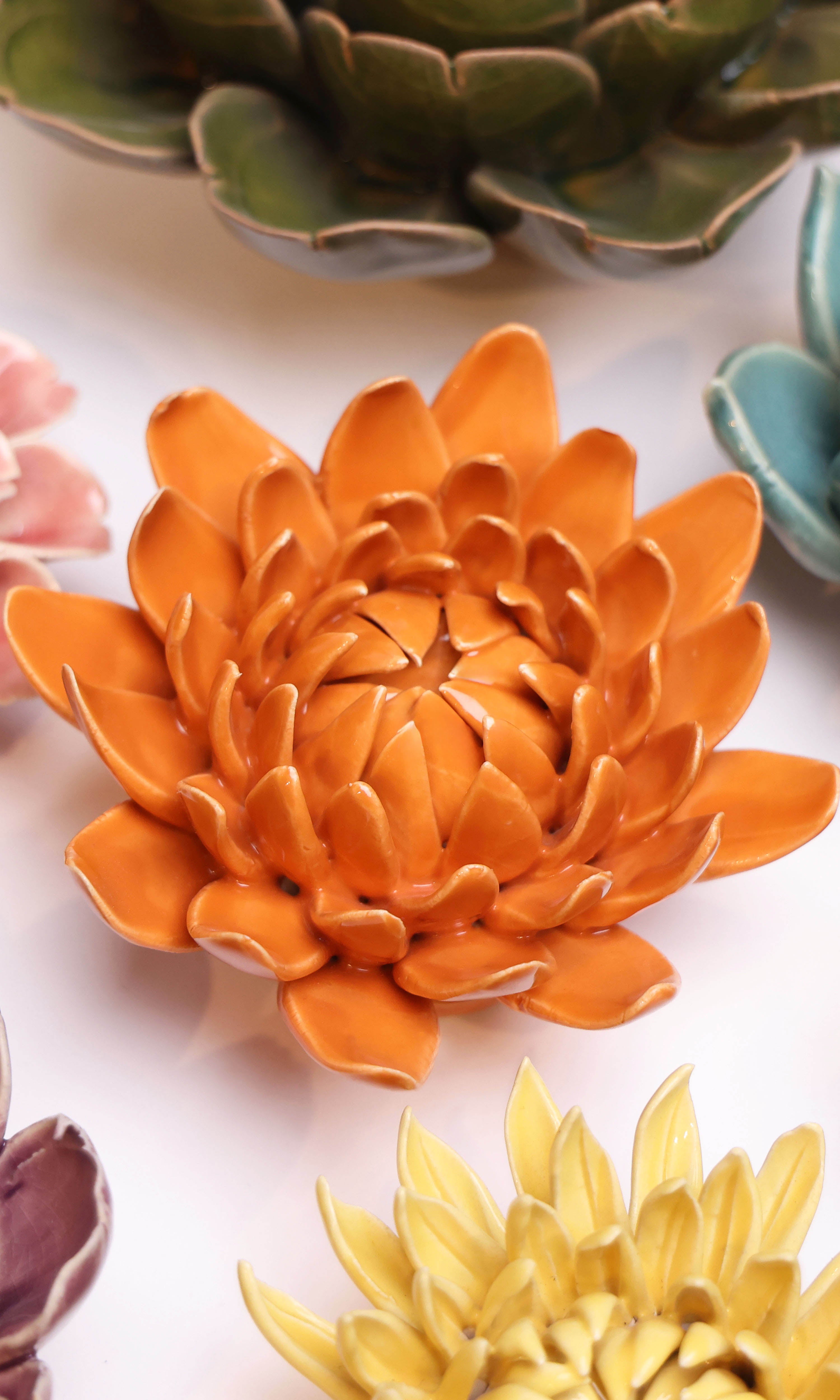 Dahlia Orange ceramic wall flower styled on wall — Classic Collection — Chive Studio Toronto