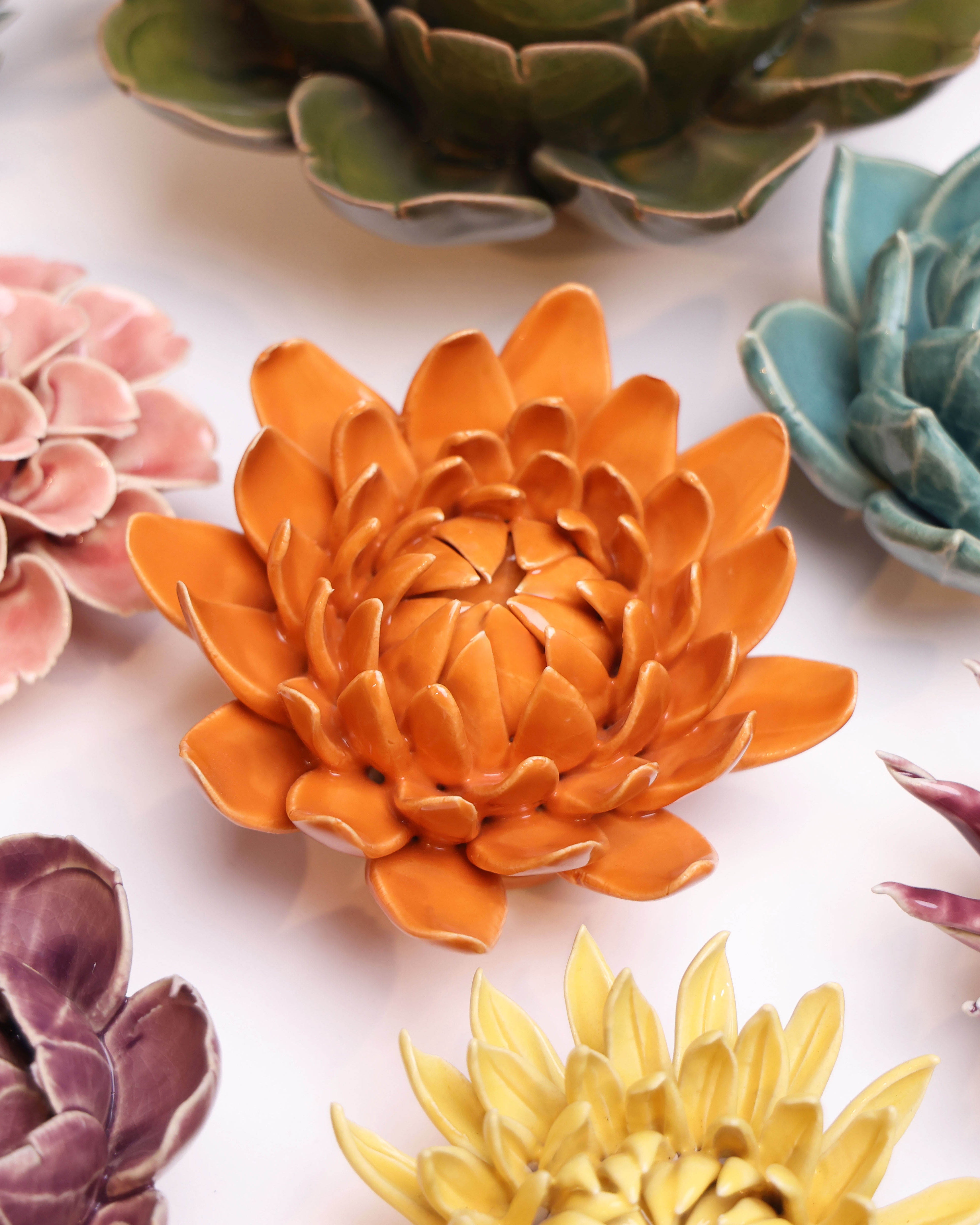 Dahlia Orange ceramic wall flower styled on wall — Classic Collection — Chive Studio Toronto