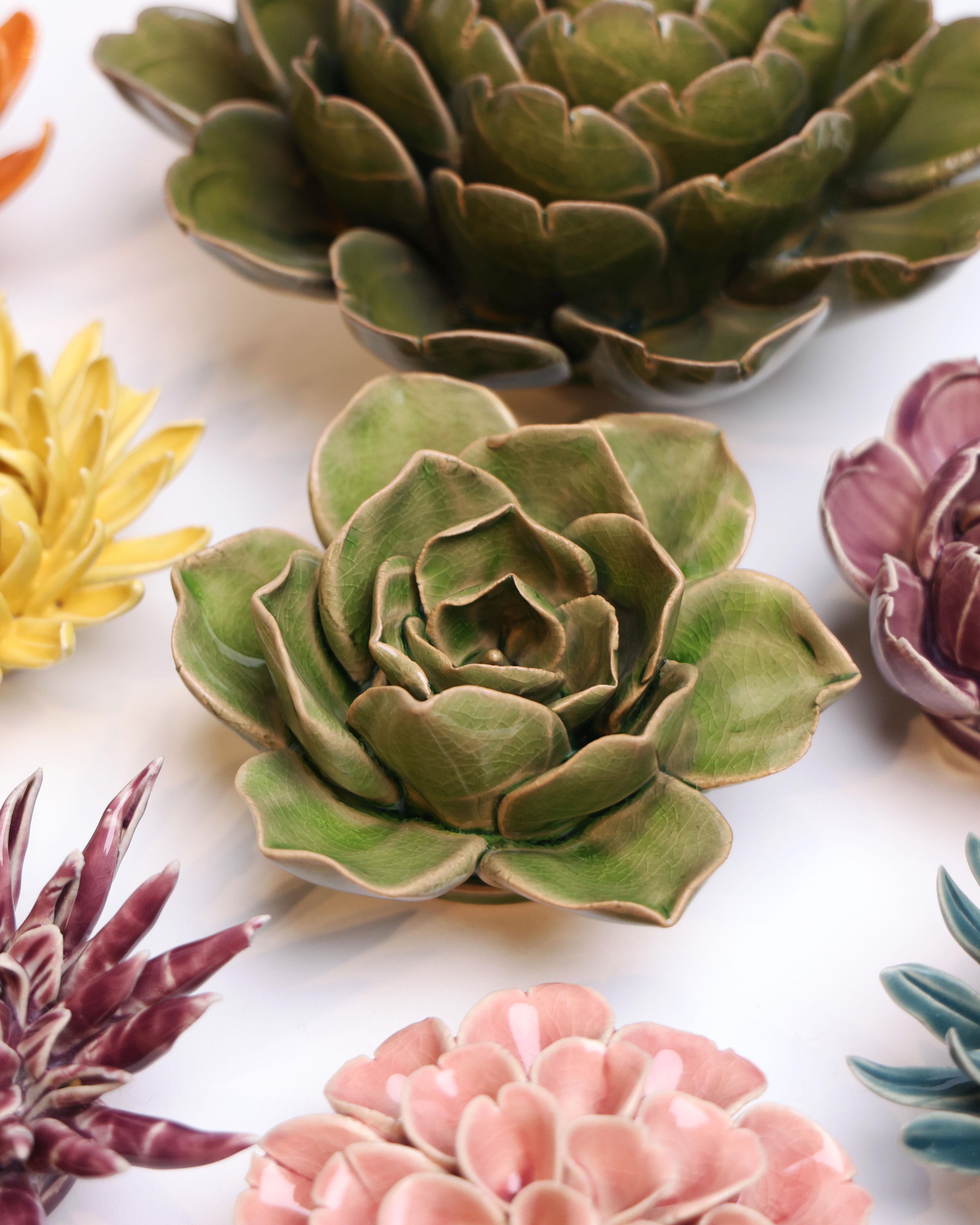 Flower Green 11 ceramic wall flower styled on a white table with other flowers — Chive Studio