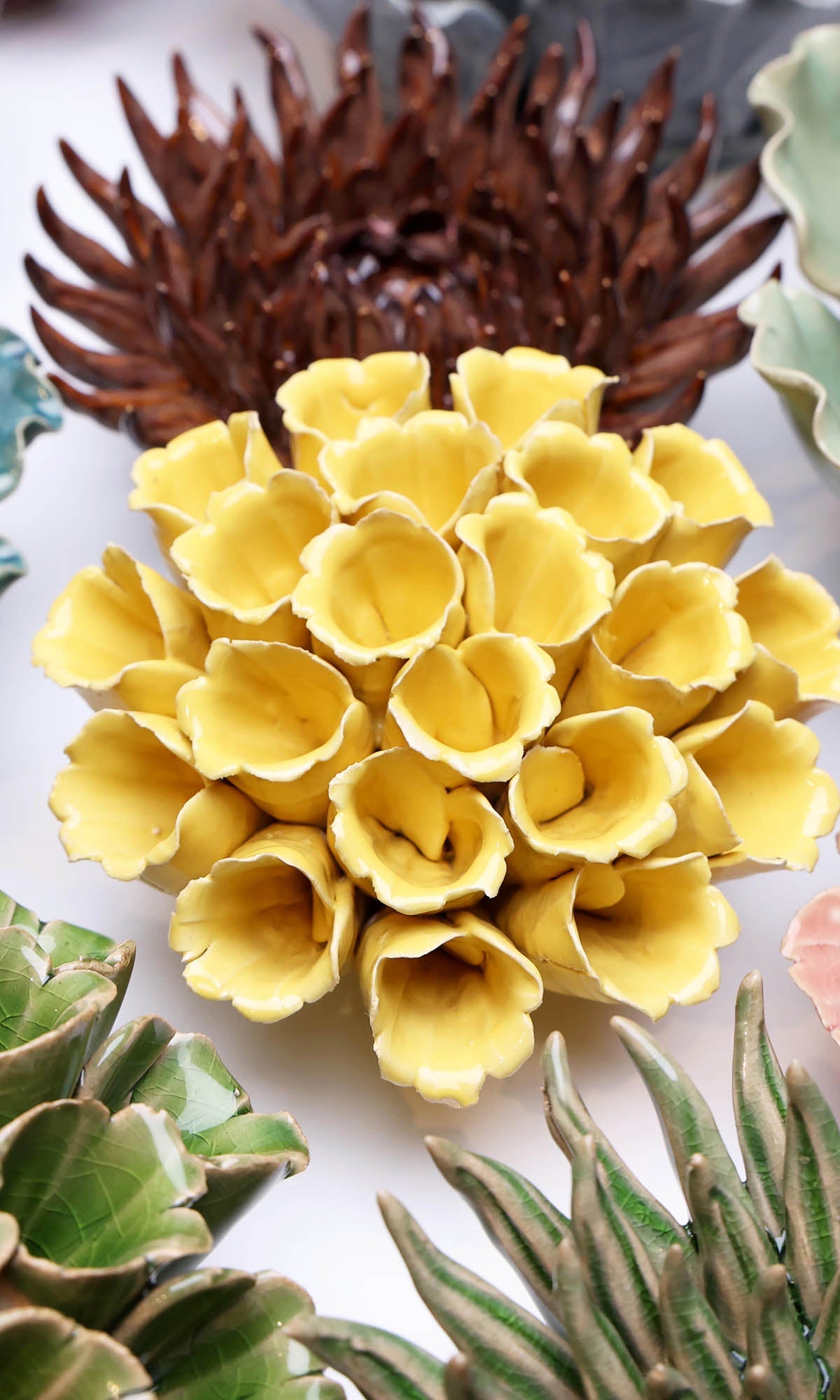 Ceramic Flower Polyp Yellow Medium ceramic wall flower styled on wall — Classic Collection — Chive Studio Toronto
