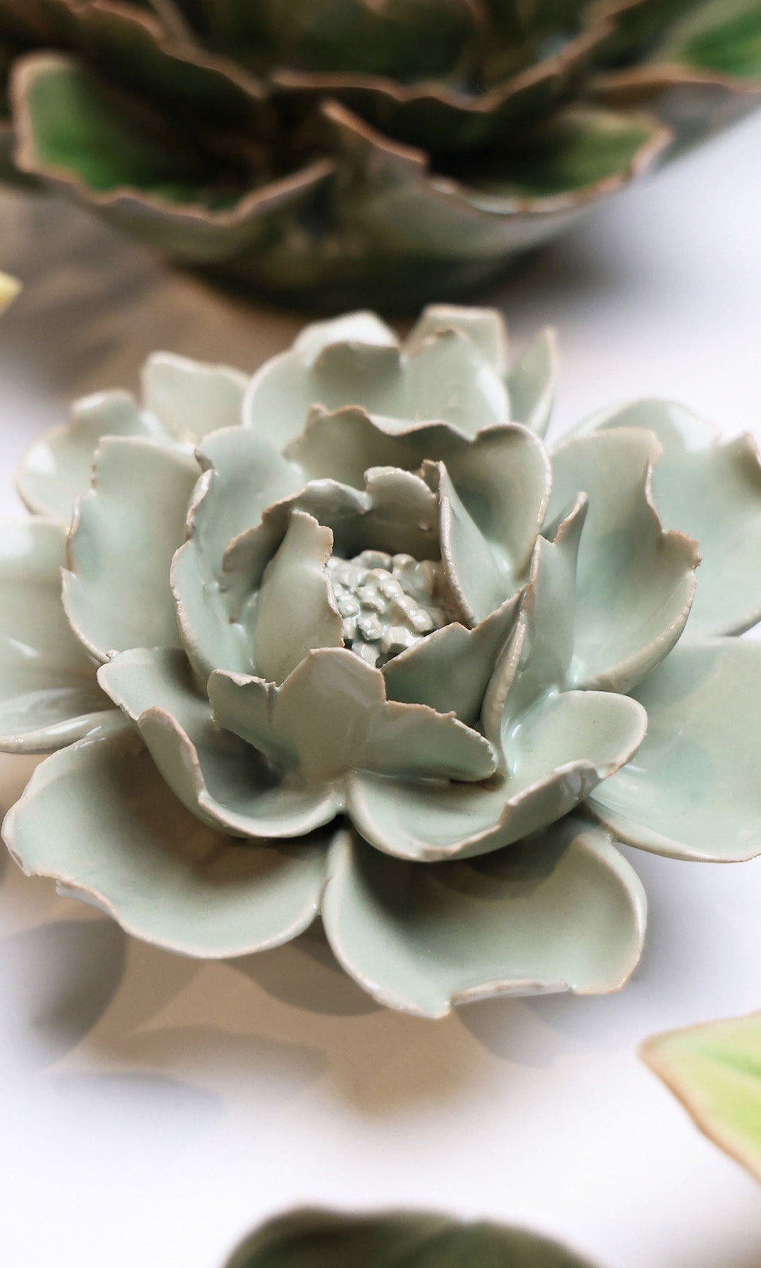 Pistachio Green Rose ceramic wall flower styled on wall — English Garden — Chive Studio Toronto
