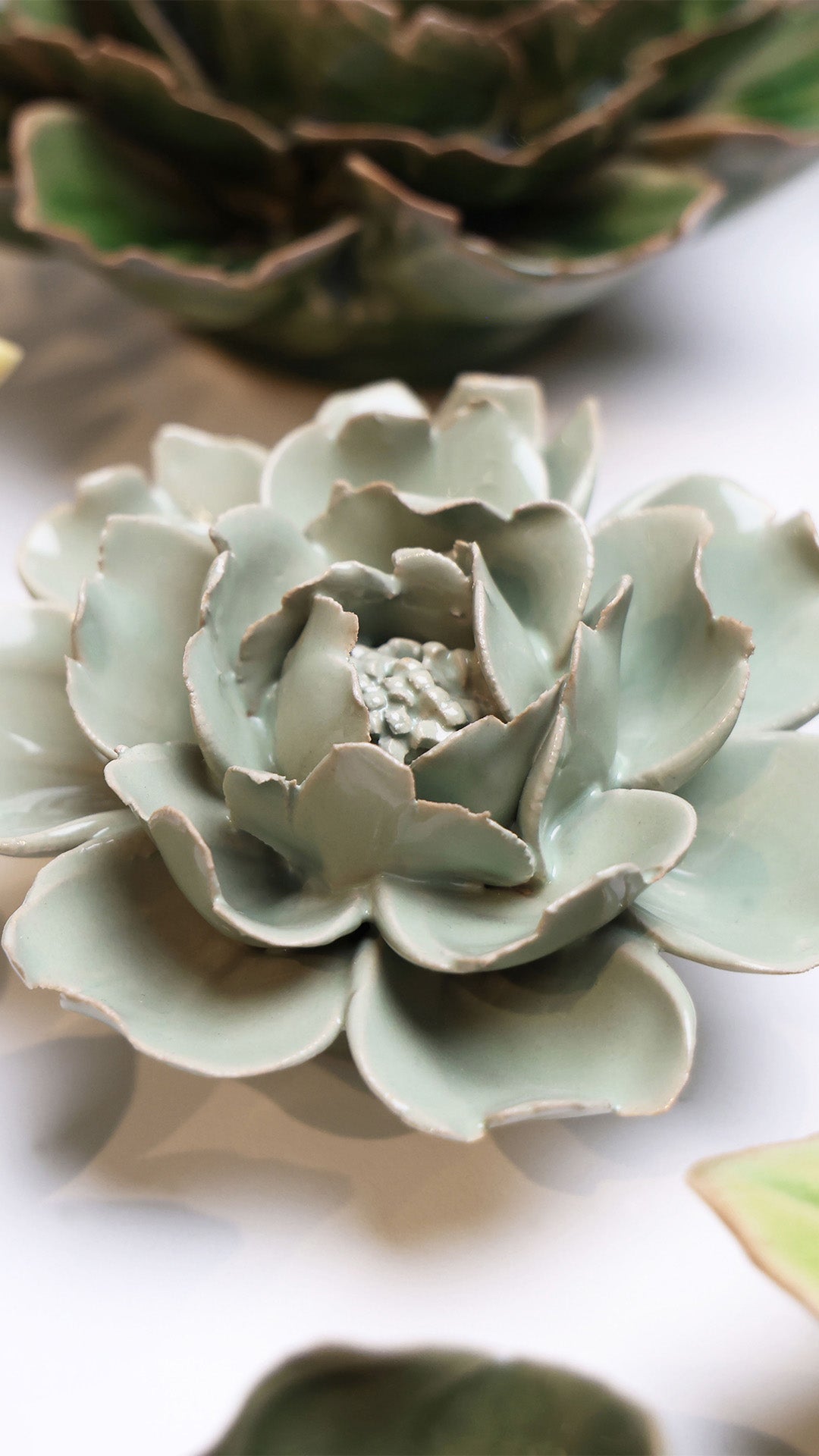 Pistachio Green Rose ceramic wall flower styled on wall — English Garden — Chive Studio Toronto