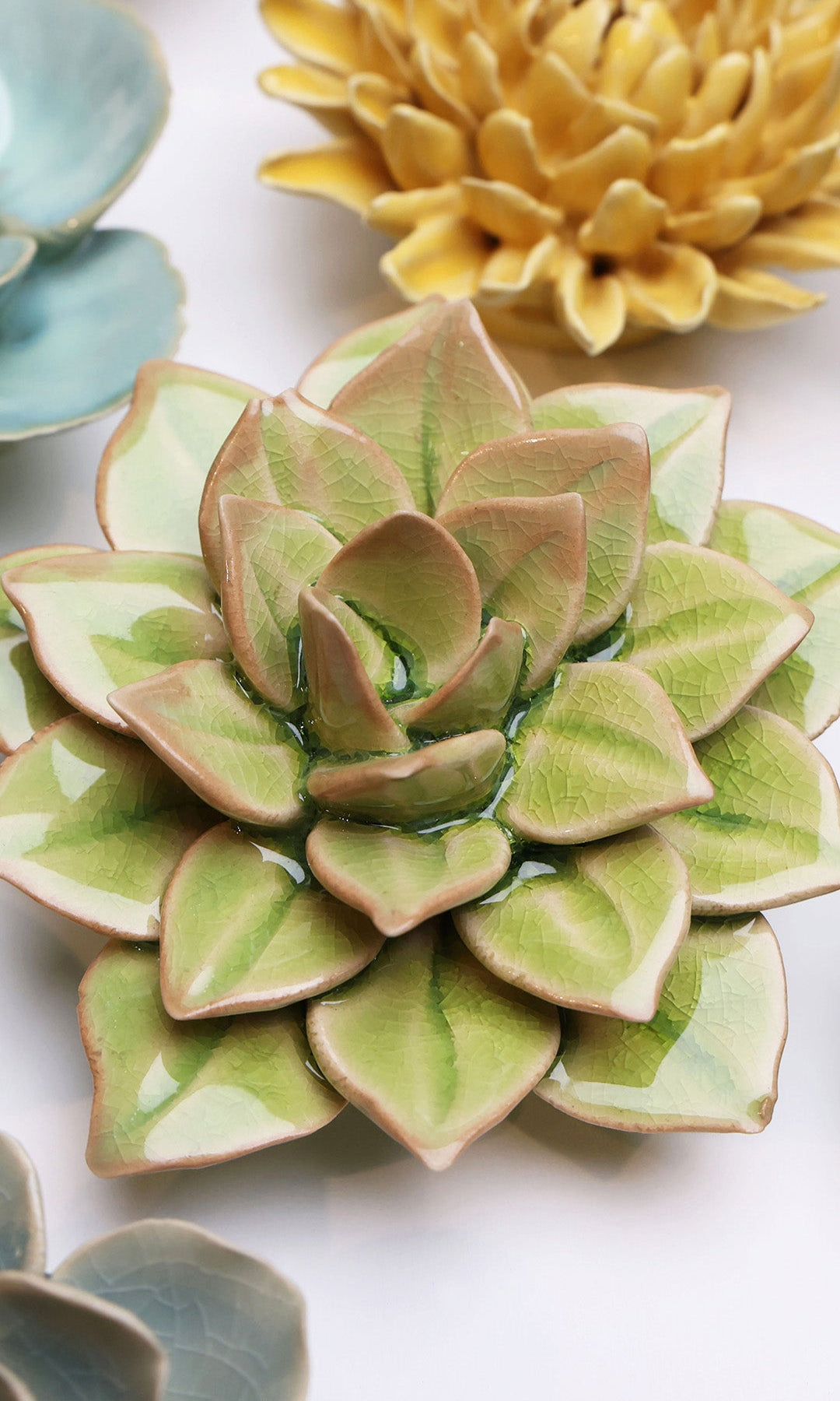 Peridot Echeveria ceramic wall flower styled on a white table with other flowers — Chive Studio