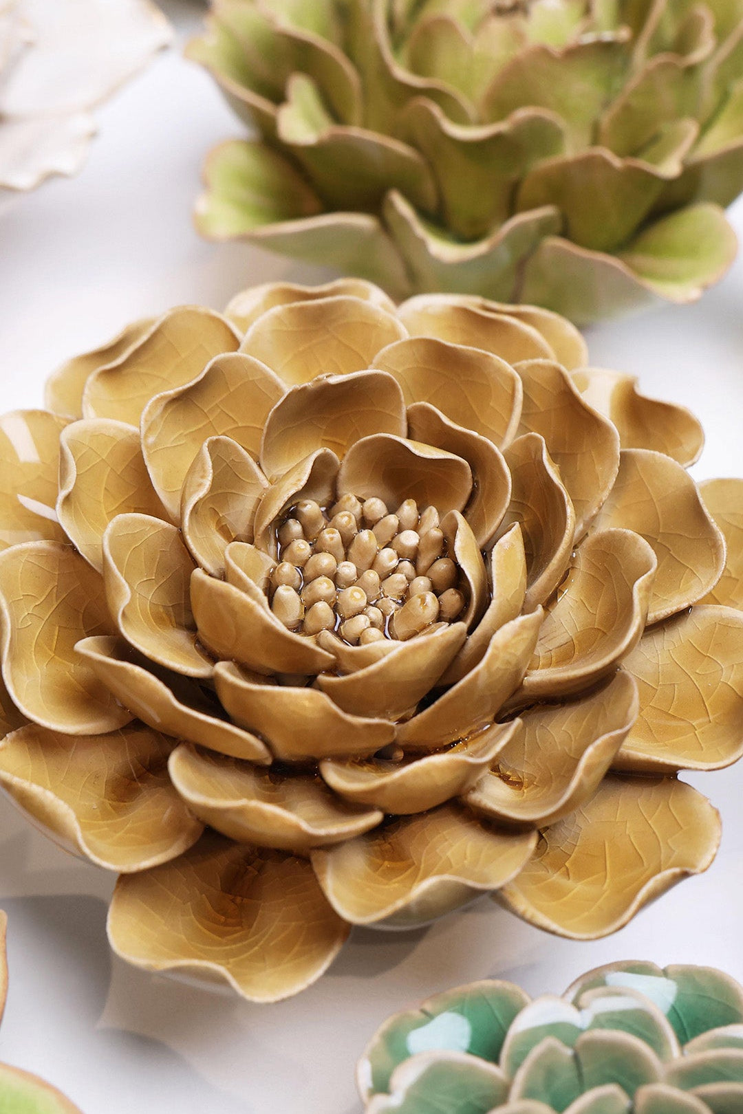 Caramel Charm Peony ceramic wall flower styled on a white table with other flowers — Chive Studio