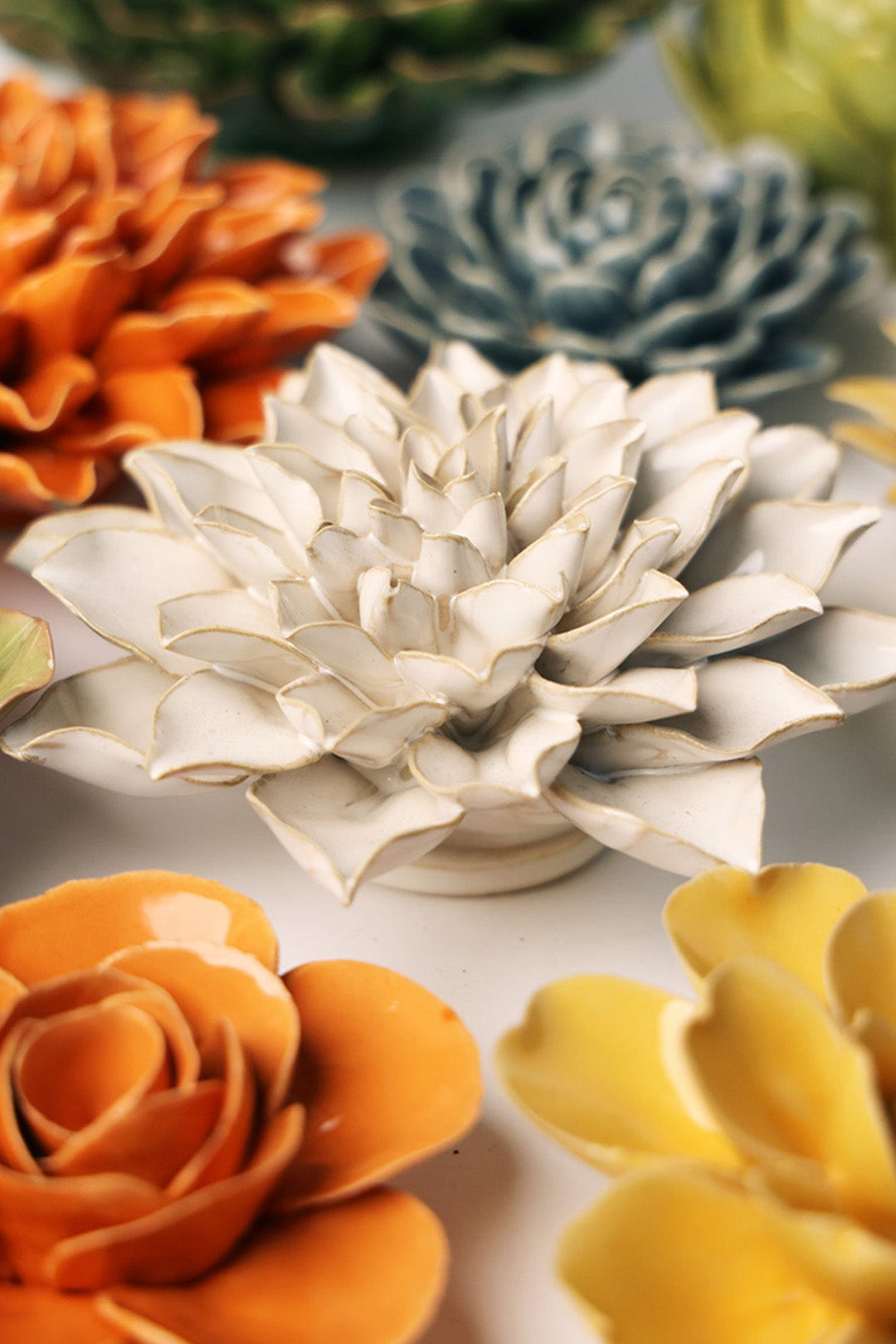 Ivory Azalea ceramic wall flower styled on a white table with other flowers — Chive Studio
