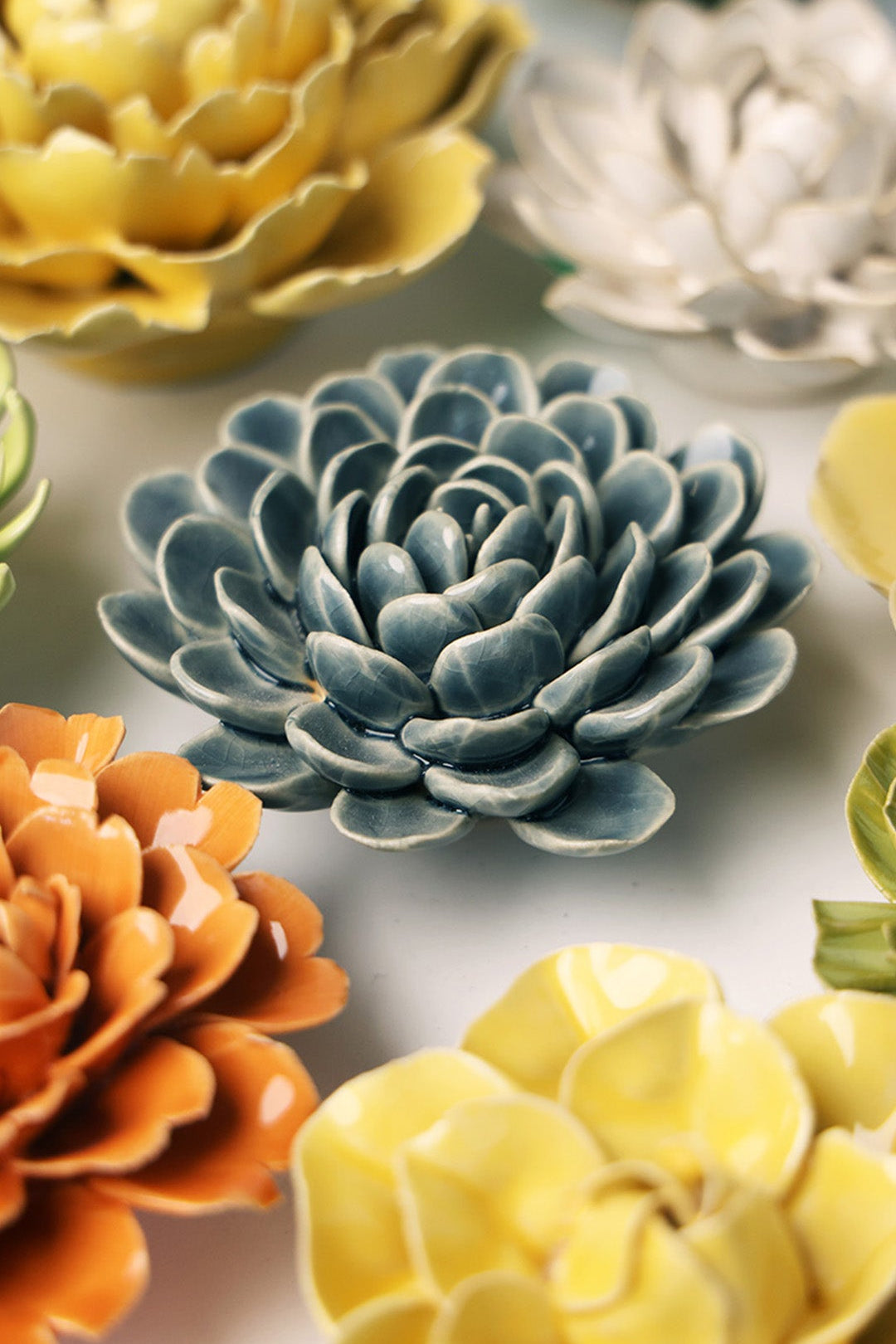 Blue Zinderella Zinnia ceramic wall flower styled on a white table with other flowers — Chive Studio