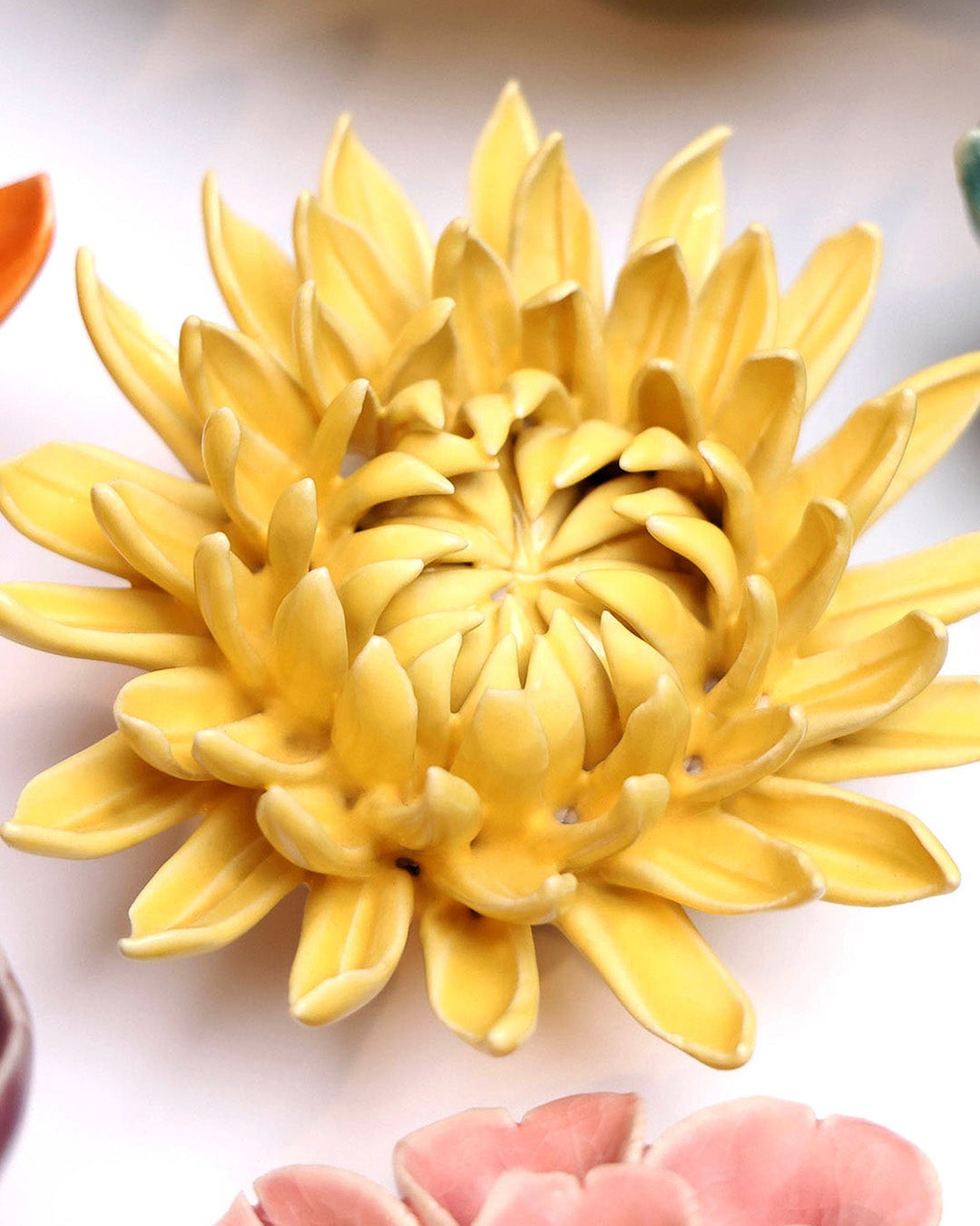 Canary Yellow Sarah Mum ceramic wall flower mounted on a wall — Chive Ceramics Studio
