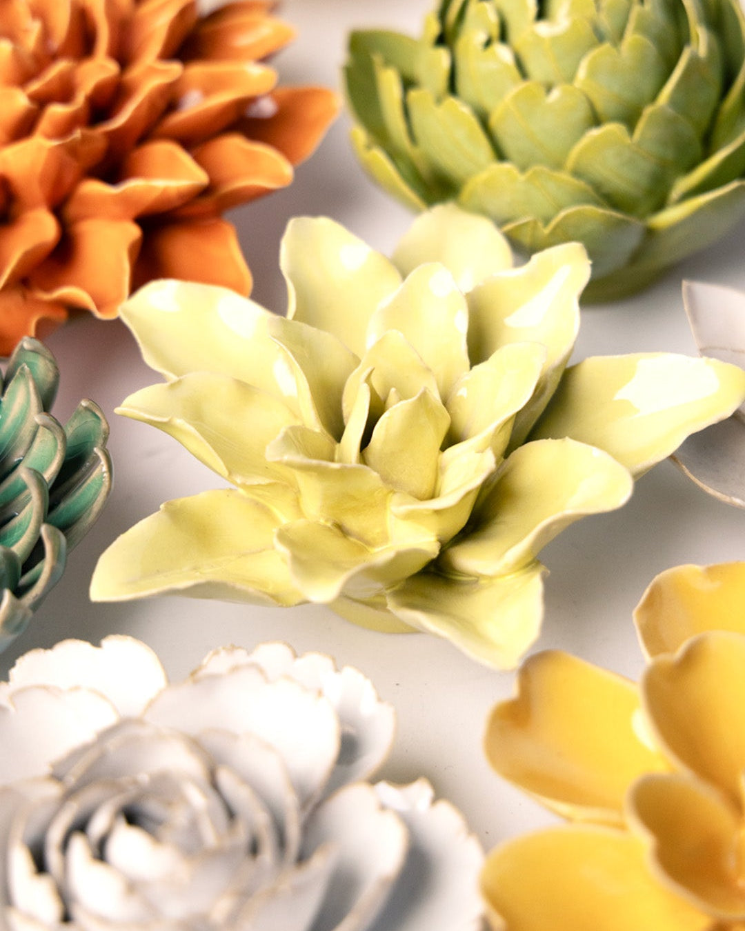 Lime Yellow Tiger Lily ceramic wall flower mounted on a wall — Chive Ceramics Studio