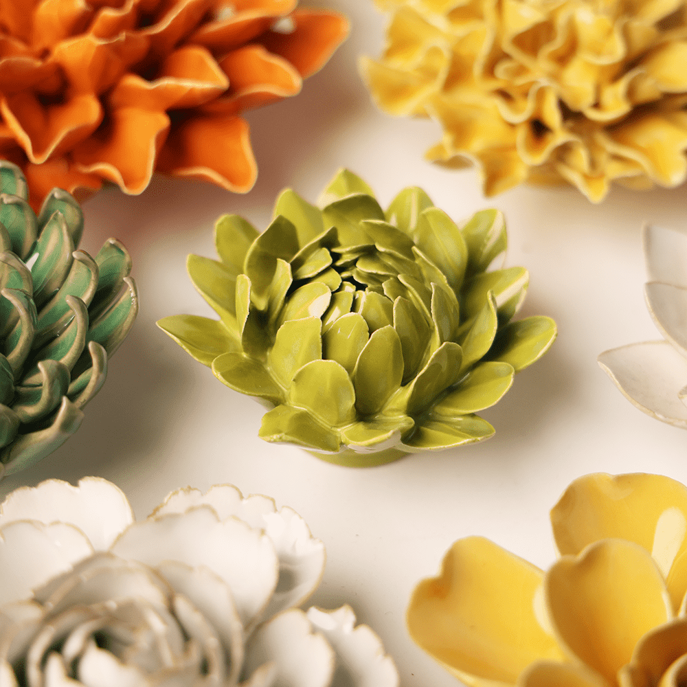 Chartreuse Sugarbush Protea ceramic wall flower mounted on a wall — Chive Ceramics Studio