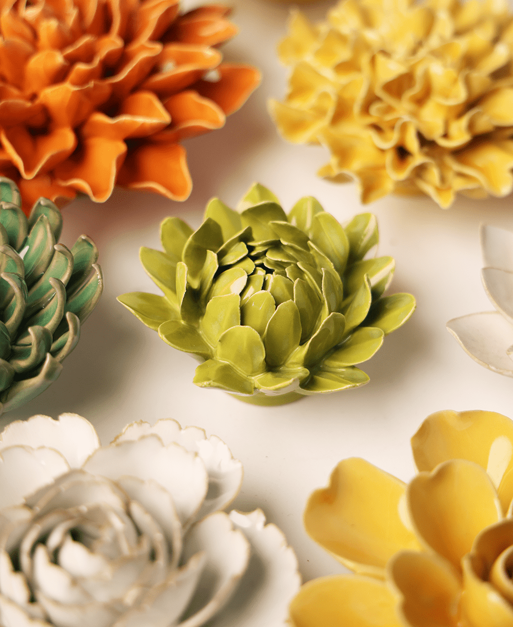 Chartreuse Sugarbush Protea ceramic wall flower mounted on a wall — Chive Ceramics Studio