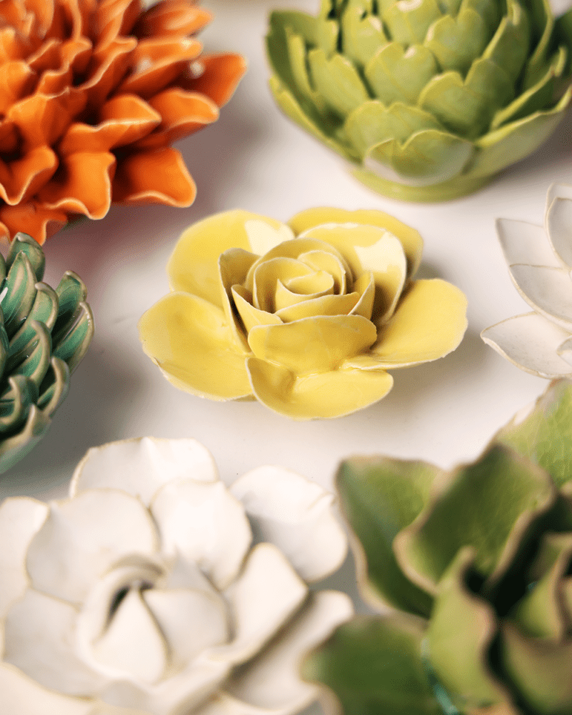 Buttercup Yellow Elegance Ranunculus ceramic wall flower mounted on a wall — Chive Ceramics Studio