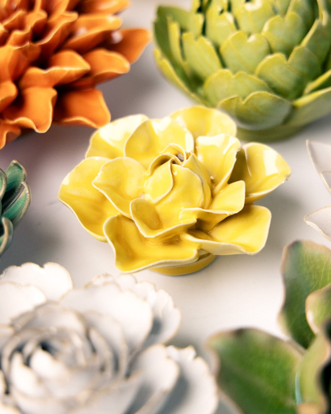Buttercup Yellow Daffodil ceramic wall flower mounted on a wall — Chive Ceramics Studio