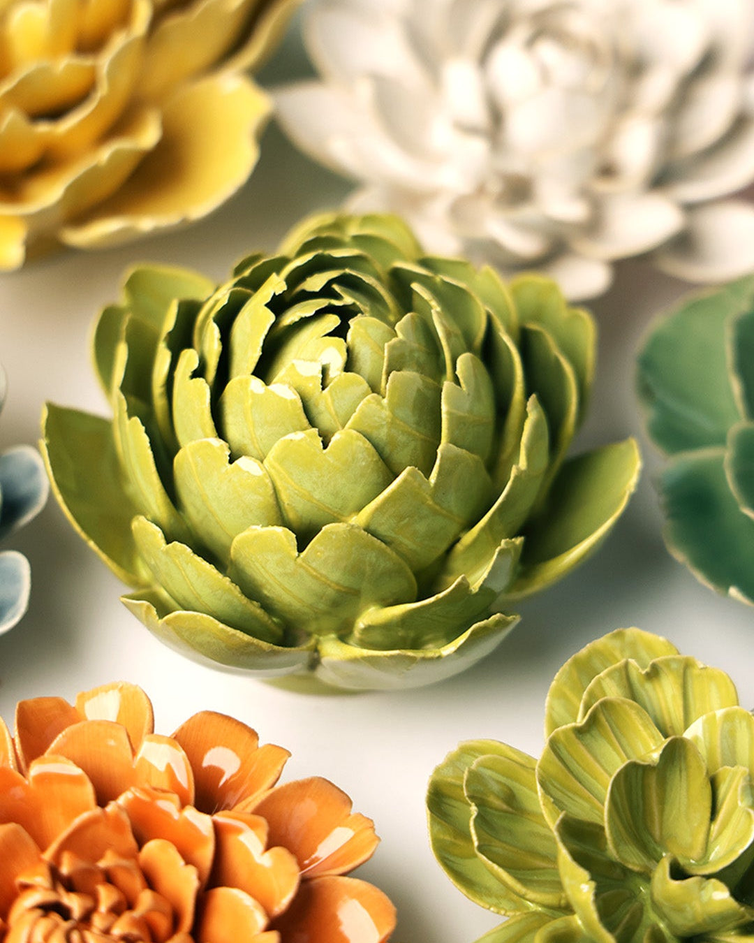 Chartreuse Queen Protea ceramic wall flower mounted on a wall — Chive Ceramics Studio