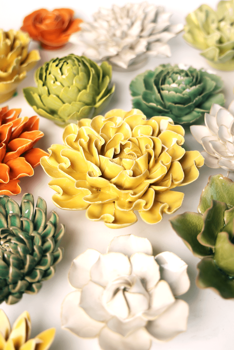 Buttercup Yellow Hawthorn ceramic wall flower styled on a white table with other flowers — Chive Studio