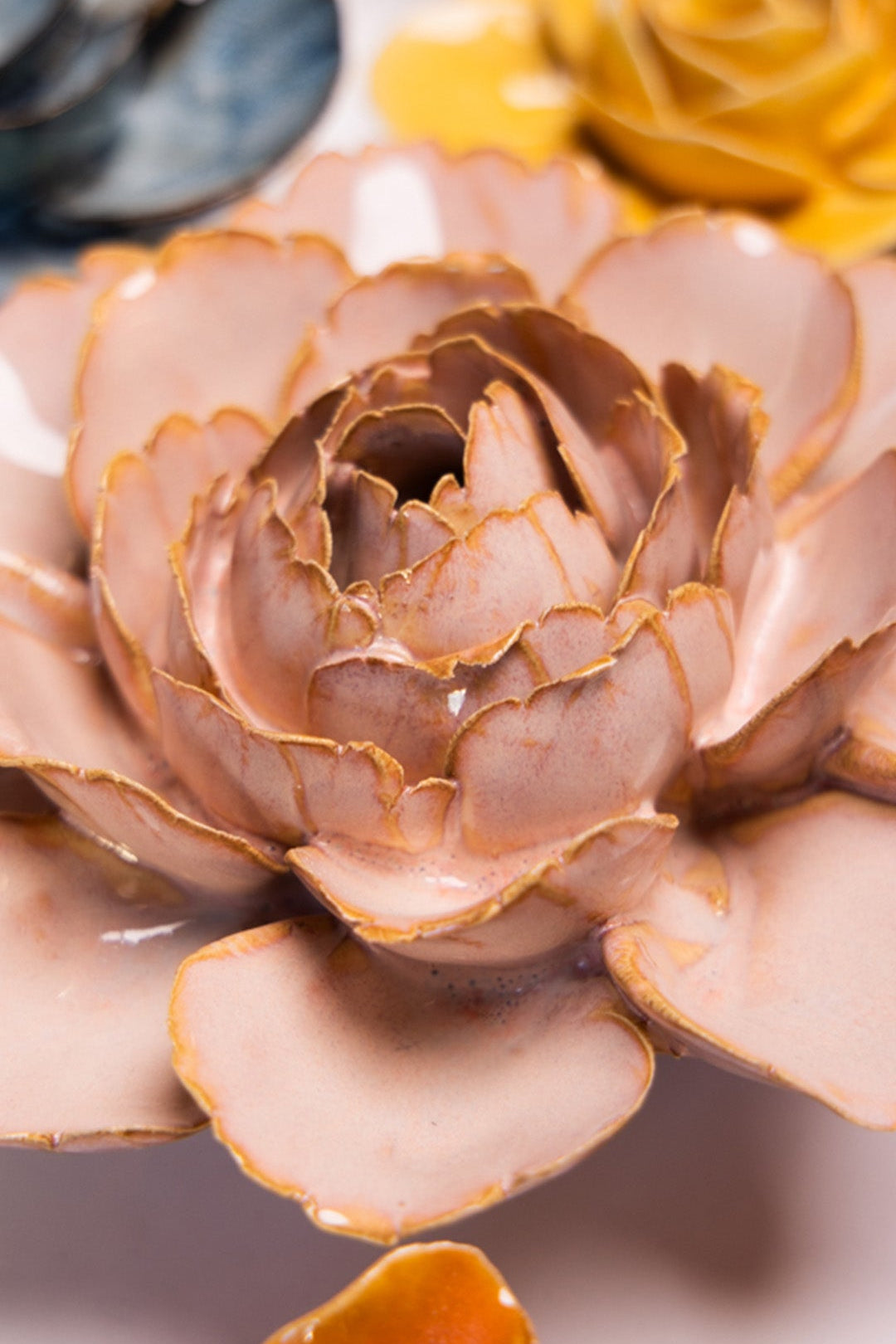Rose Pink Camellia ceramic wall flower styled on a white table with other flowers — Chive Studio