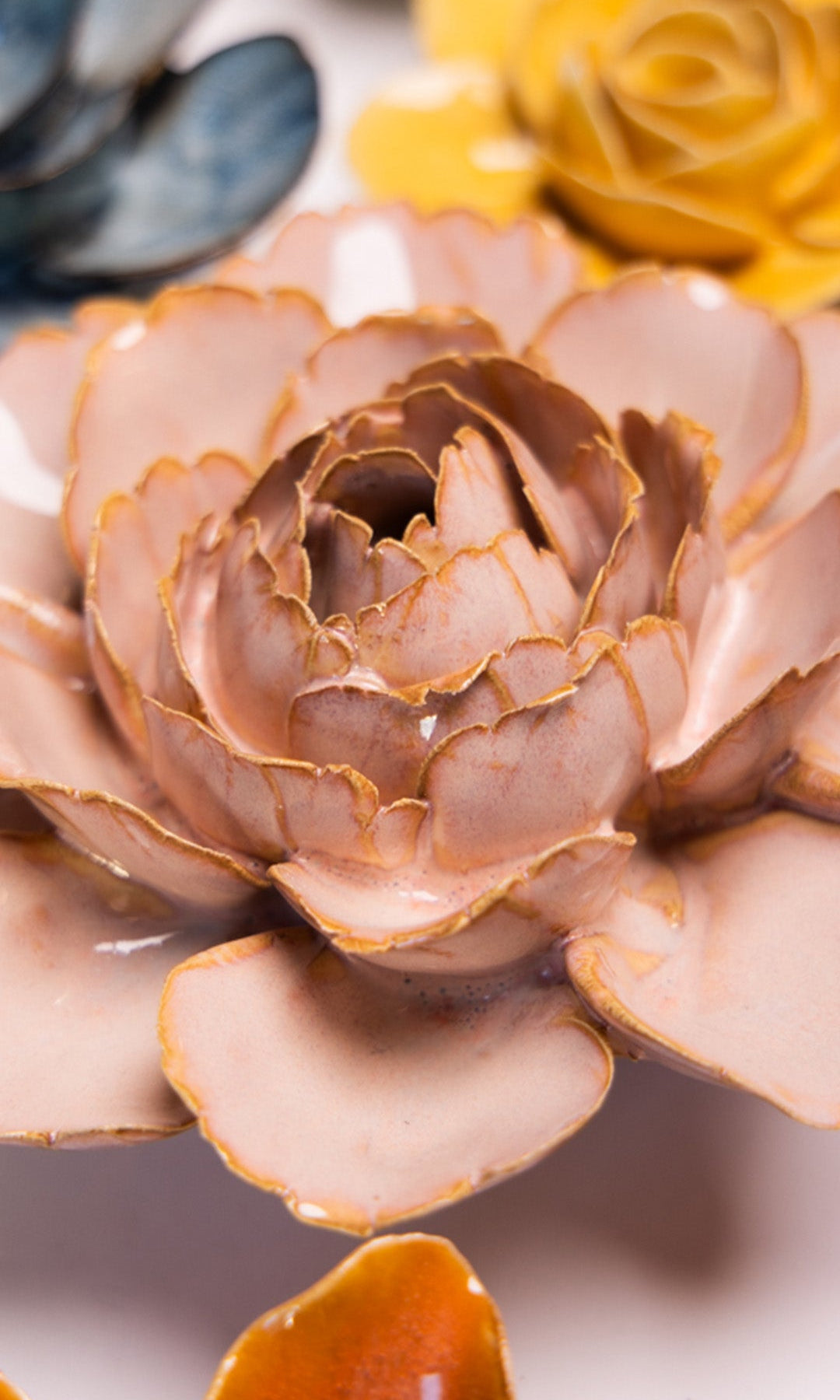 Rose Pink Camellia ceramic wall flower styled on a white table with other flowers — Chive Studio