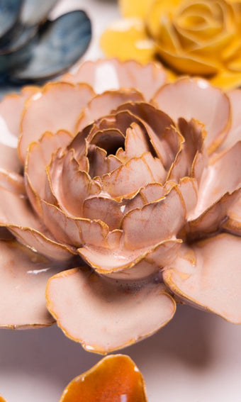 Rose Pink Camellia ceramic wall flower styled on a white table with other flowers — Chive Studio