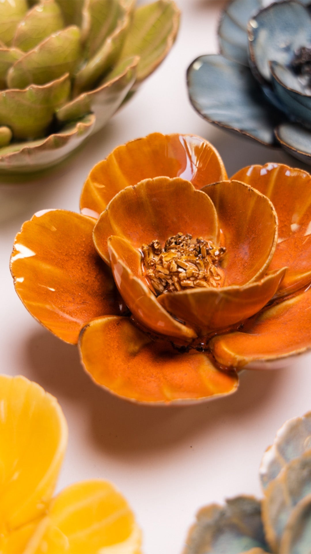 Orange Poppy ceramic wall flower styled on a white table with other flowers — Chive Studio