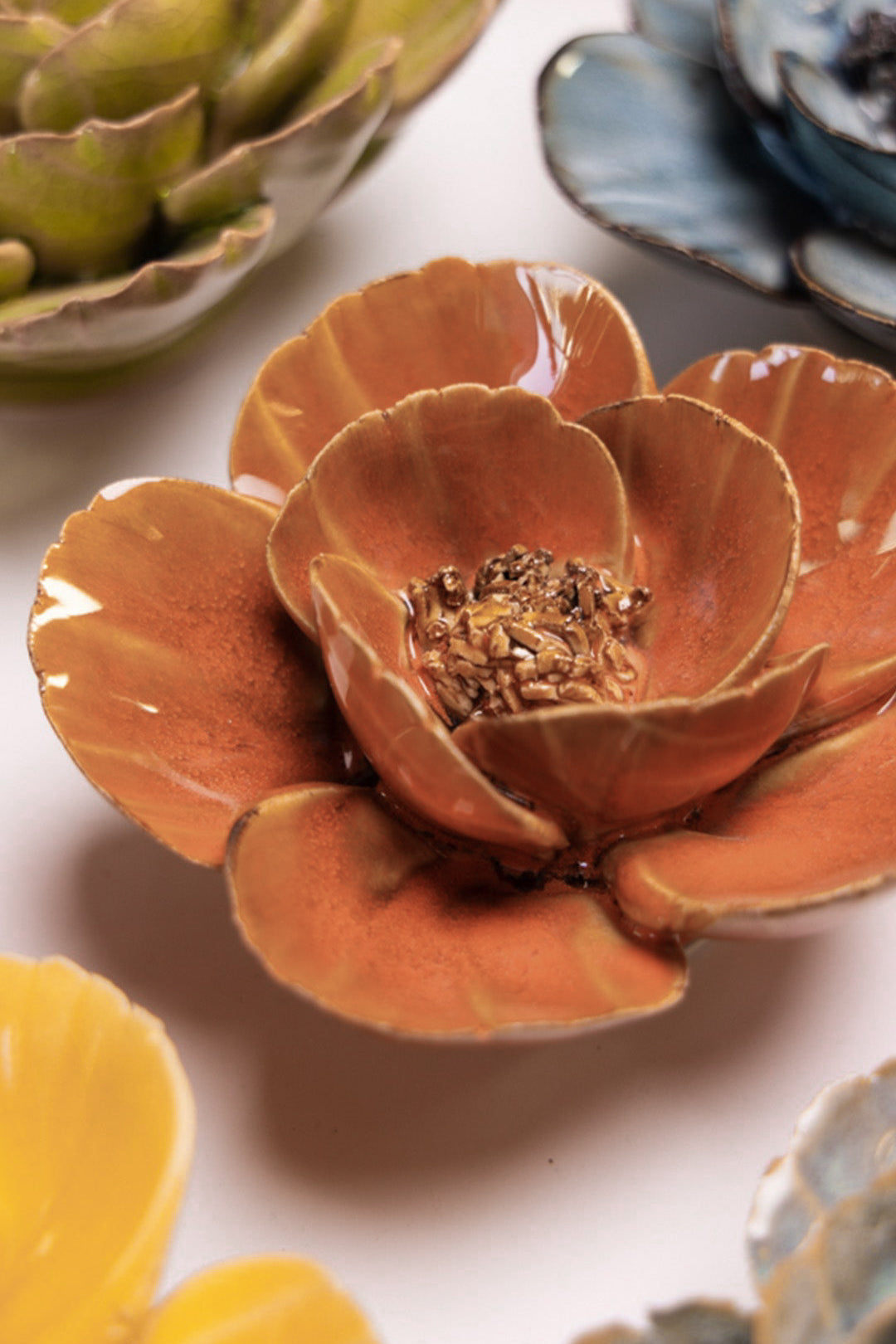 Orange Poppy ceramic wall flower styled on a white table with other flowers — Chive Studio