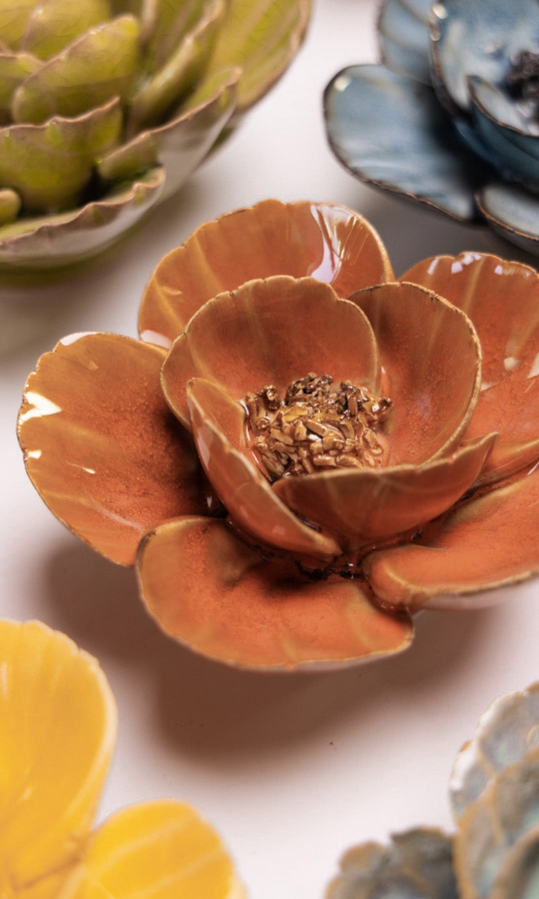 Orange Poppy ceramic wall flower styled on a white table with other flowers — Chive Studio