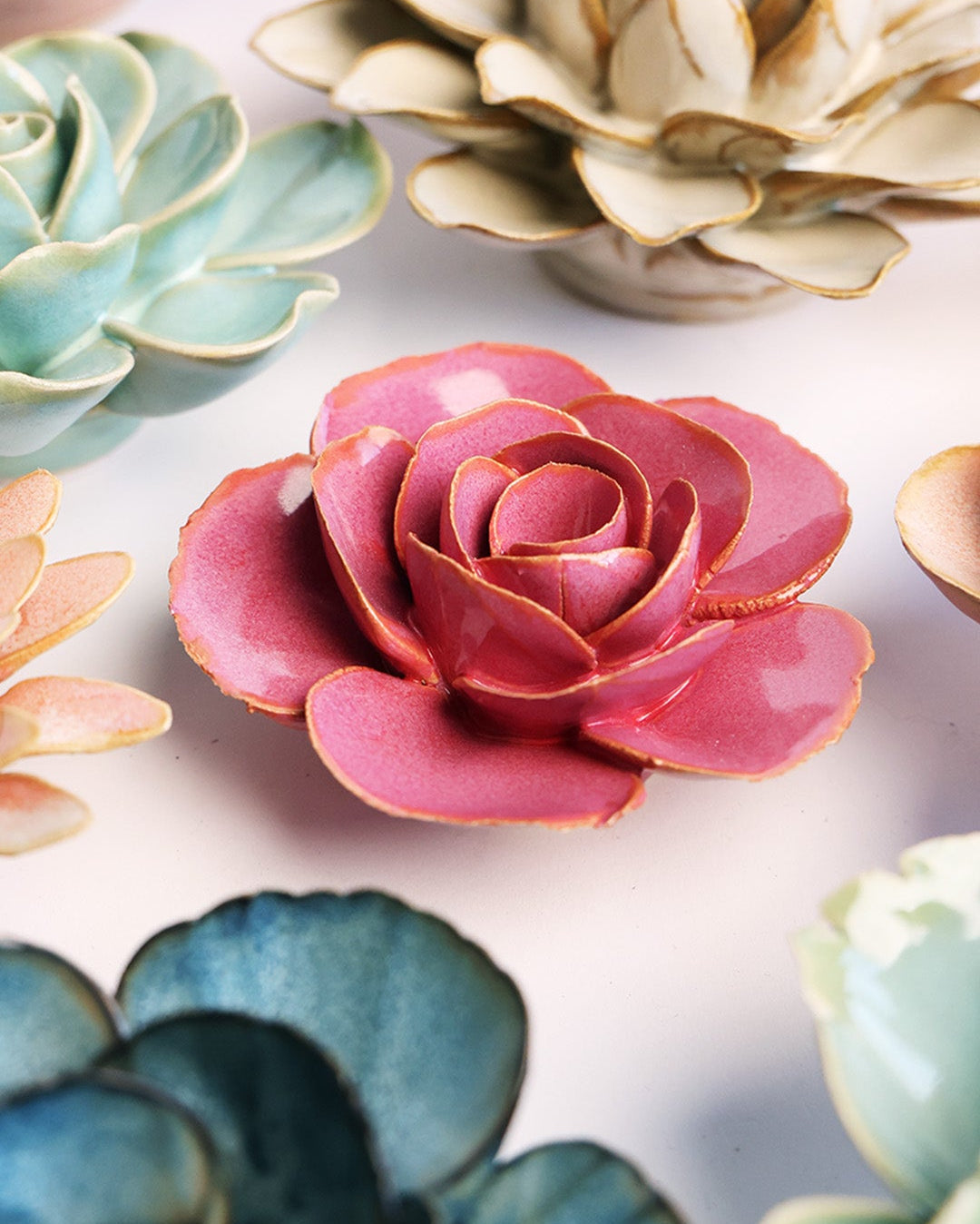 Blush Pink Elegance Ranunculus ceramic wall flower styled on a white table with other flowers — Chive Studio