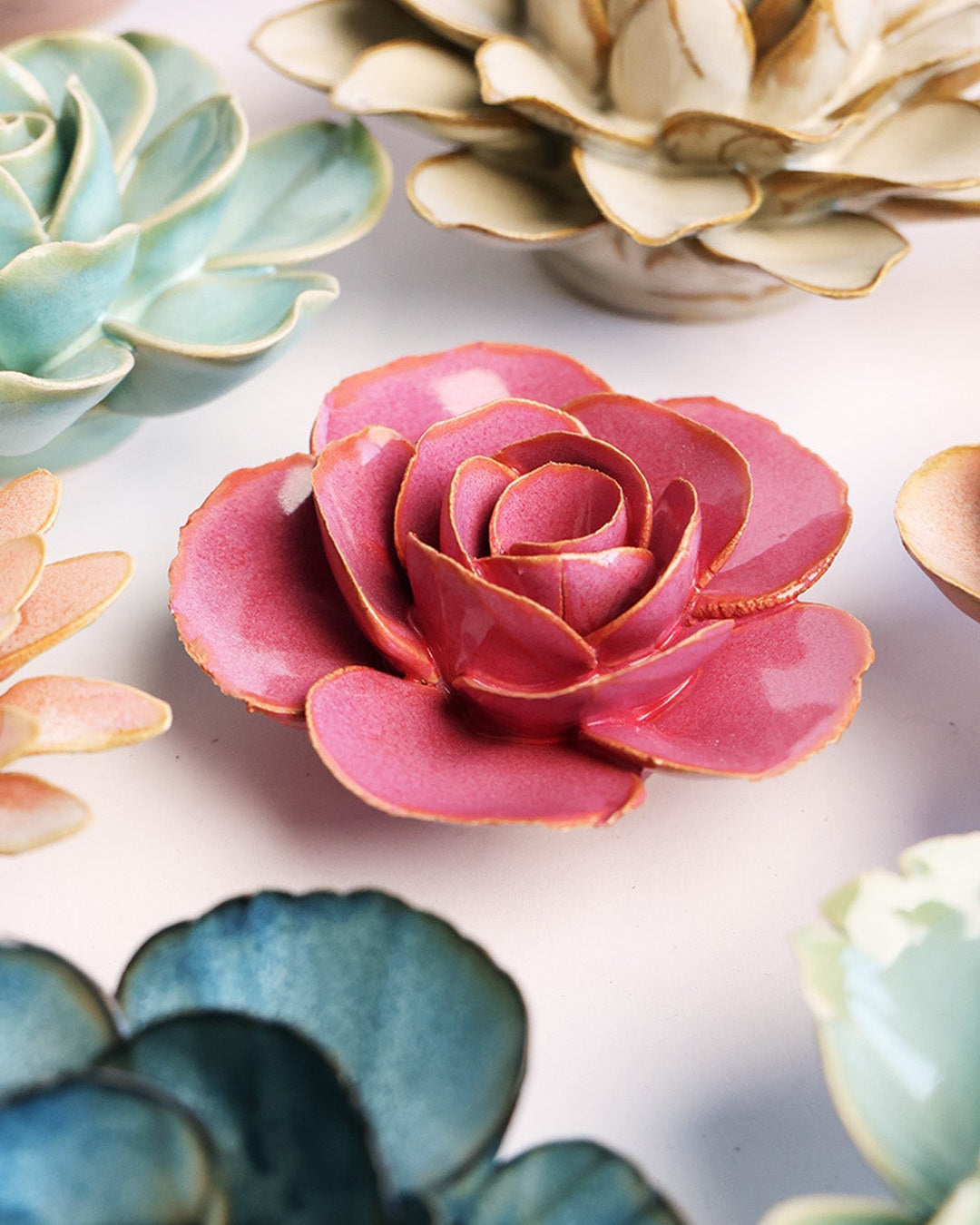 Blush Pink Elegance Ranunculus ceramic wall flower styled on a white table with other flowers — Chive Studio