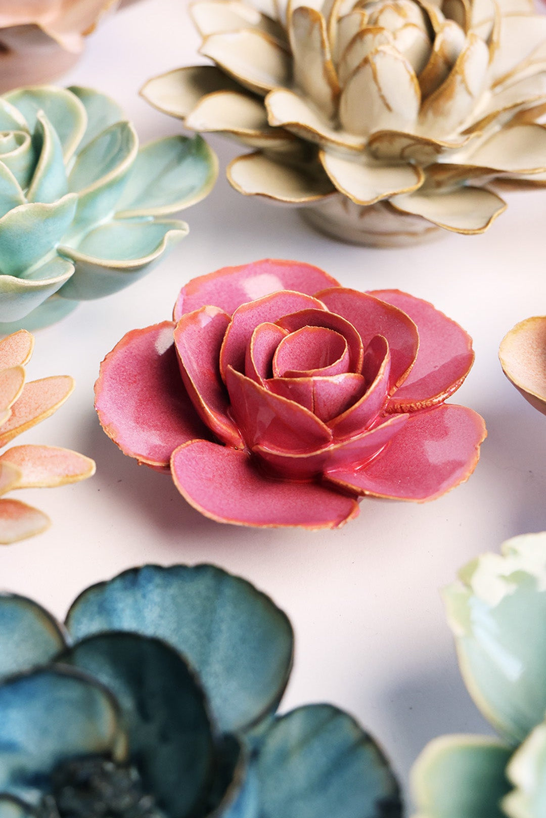 Blush Pink Elegance Ranunculus ceramic wall flower styled on a white table with other flowers — Chive Studio