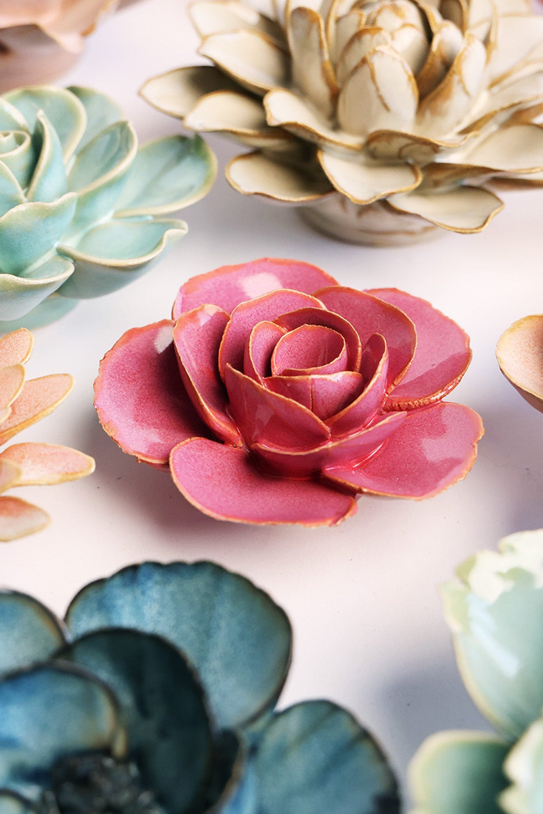 Blush Pink Elegance Ranunculus ceramic wall flower styled on a white table with other flowers — Chive Studio