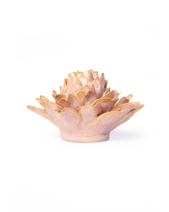 A small sculptural lotus flower vase or candle holder with layered petals, finished in a soft blush pink with metallic gold edging, photographed on a clean white background.