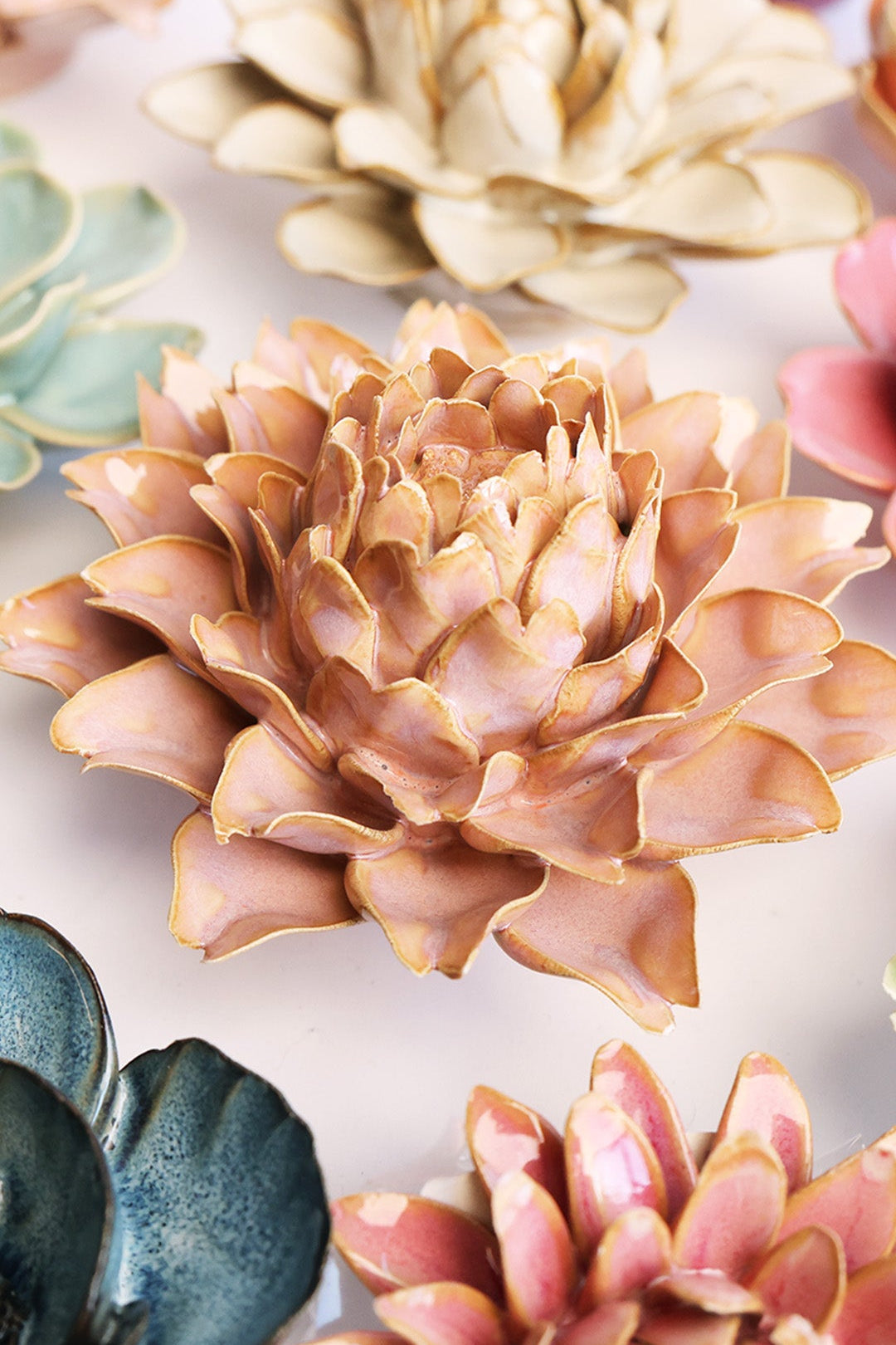 Rose Pink Protea ceramic wall flower styled on a white table with other flowers — Chive Studio
