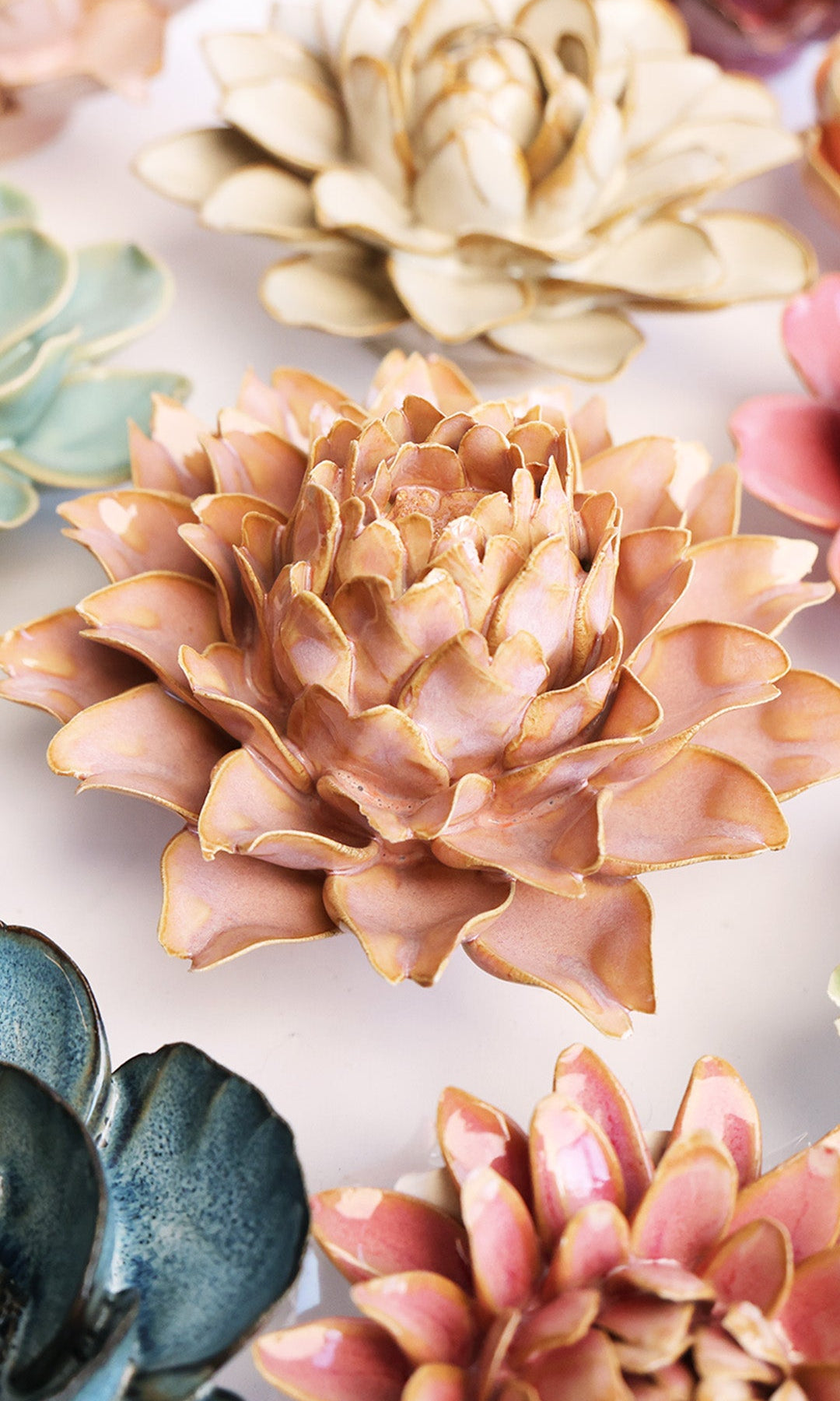 Rose Pink Protea ceramic wall flower styled on a white table with other flowers — Chive Studio
