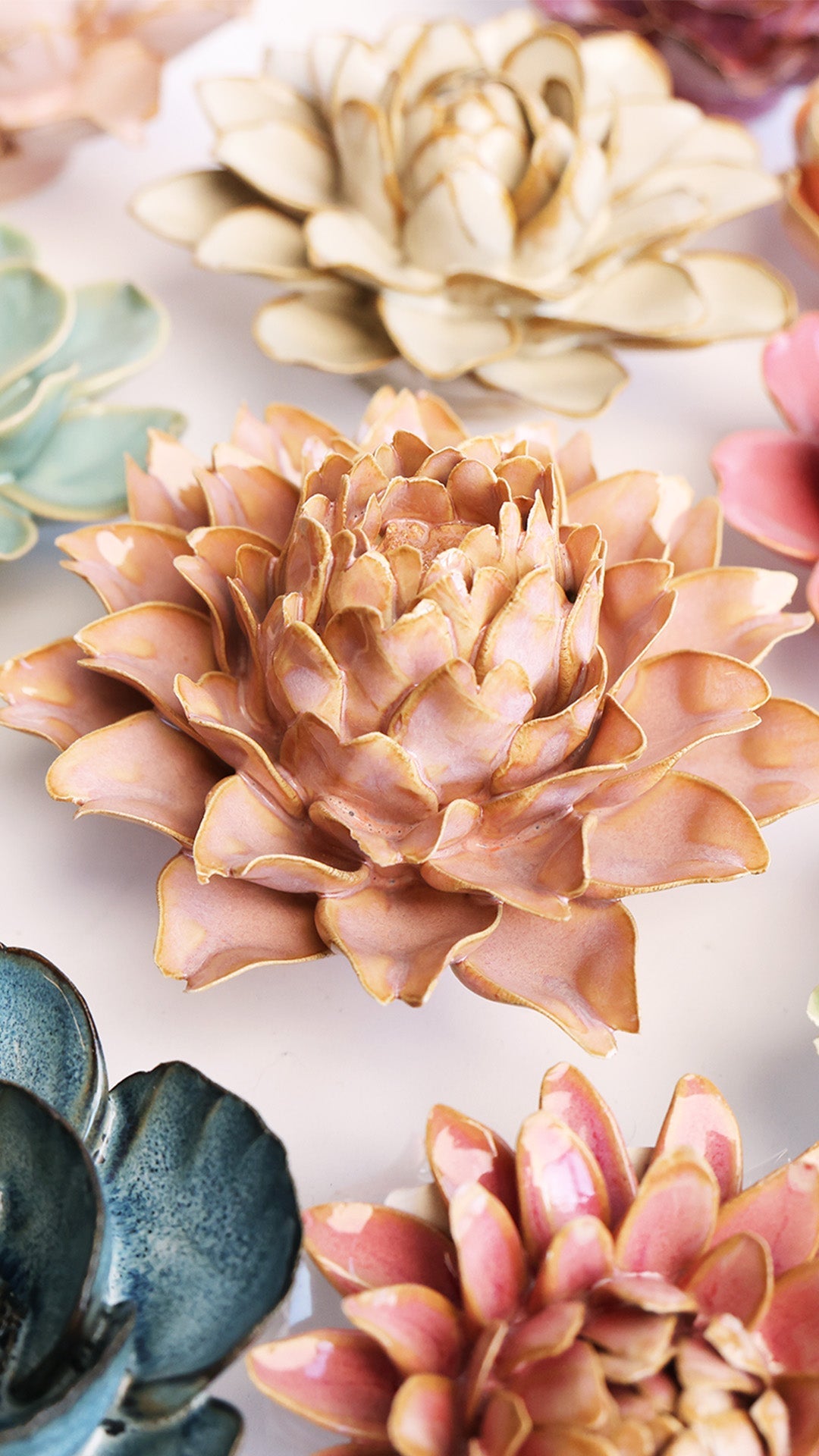 Rose Pink Protea ceramic wall flower styled on a white table with other flowers — Chive Studio
