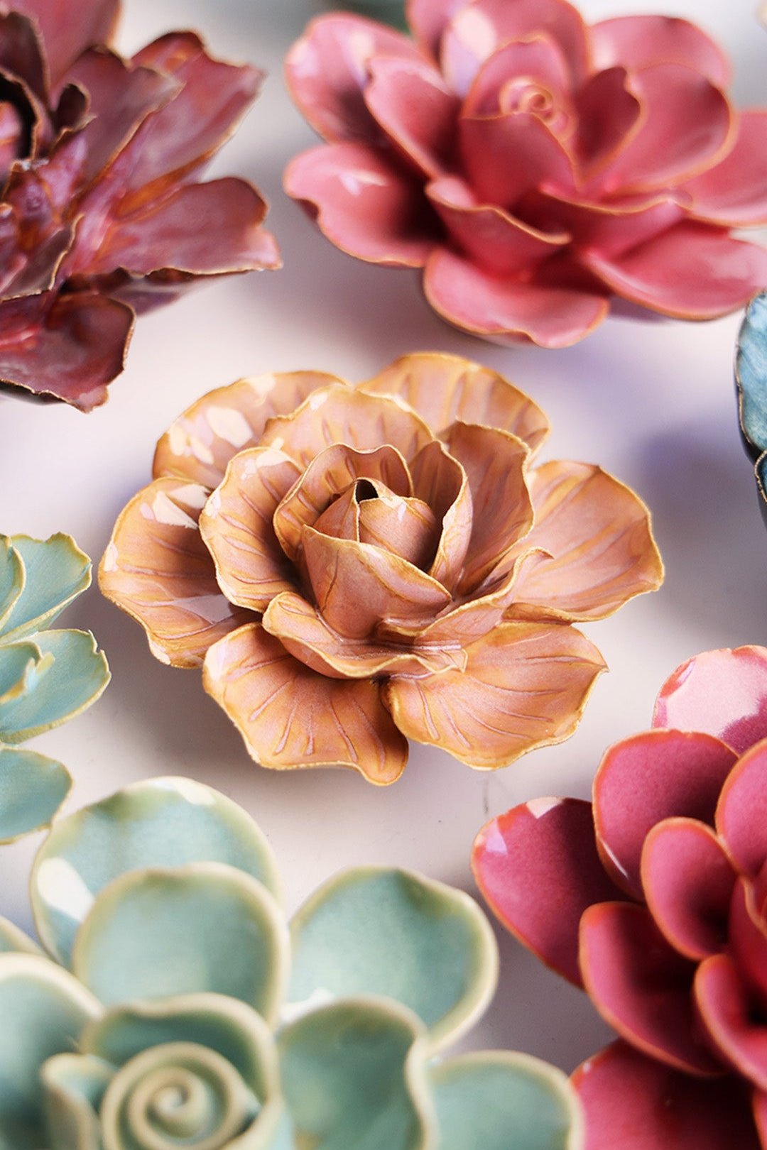 Peach Pink Carnation ceramic wall flower styled on a white table with other flowers — Chive Studio