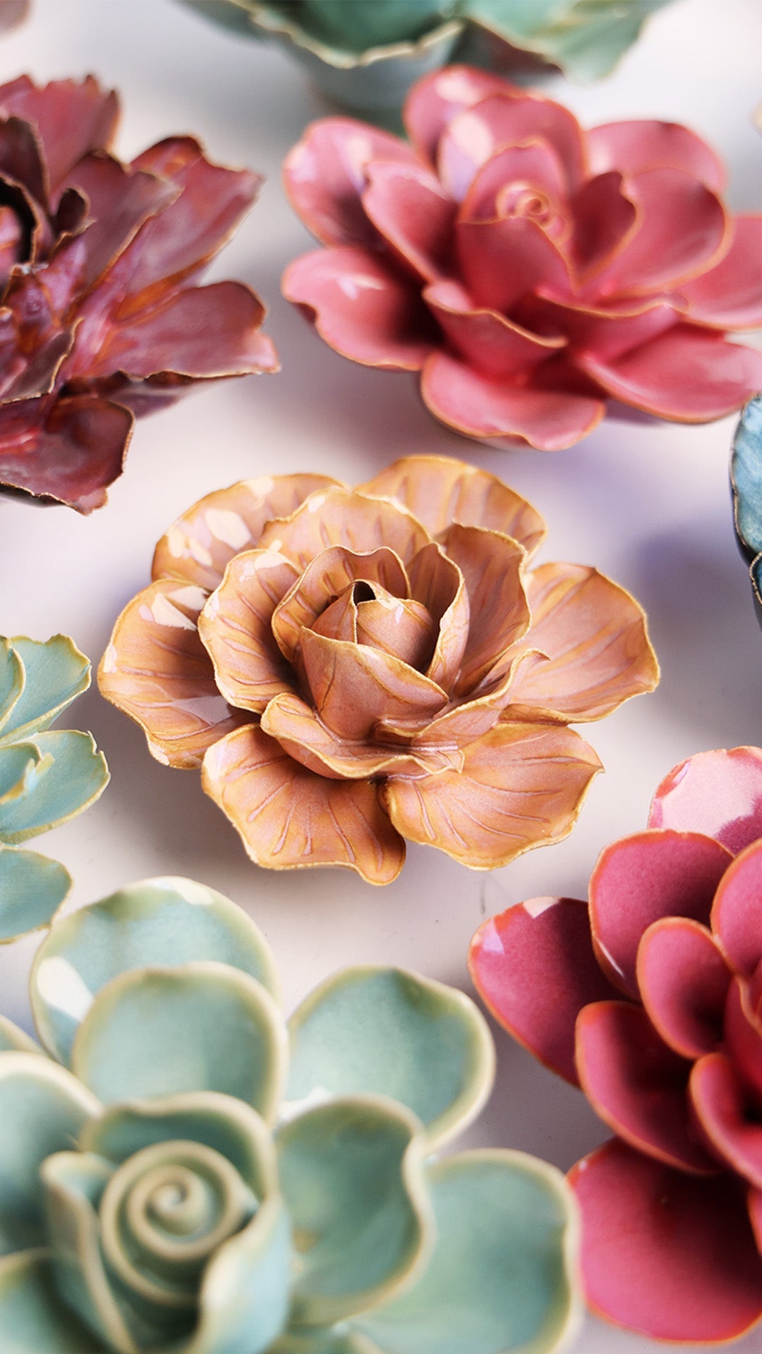Peach Pink Carnation ceramic wall flower styled on a white table with other flowers — Chive Studio