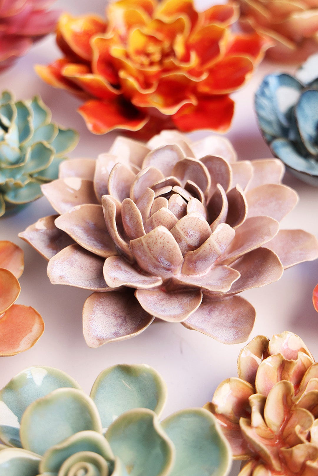 Pink Water Lily ceramic wall flower styled on a white table with other flowers — Chive Studio