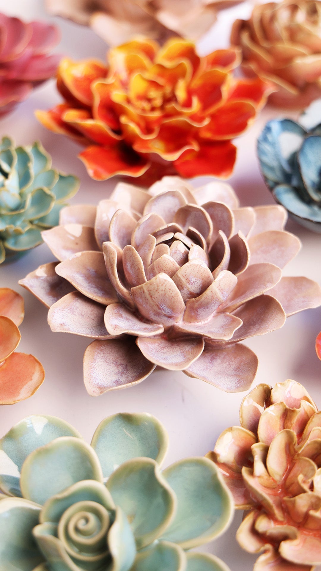 Pink Water Lily ceramic wall flower styled on a white table with other flowers — Chive Studio