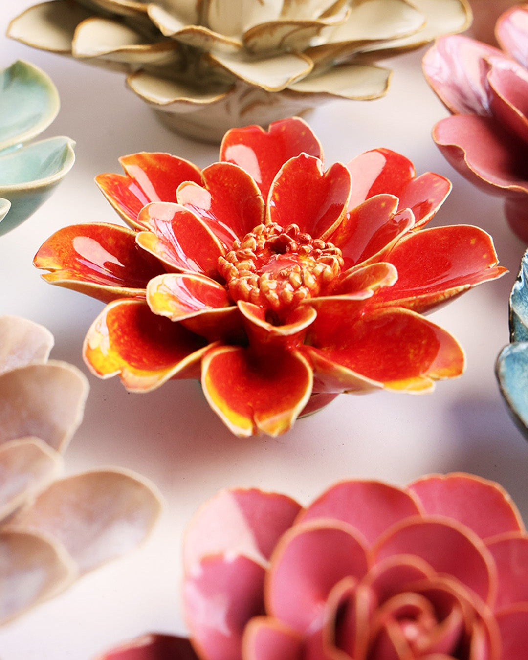 Yellow Daisy ceramic wall flower styled on a white table with other flowers — Chive Studio