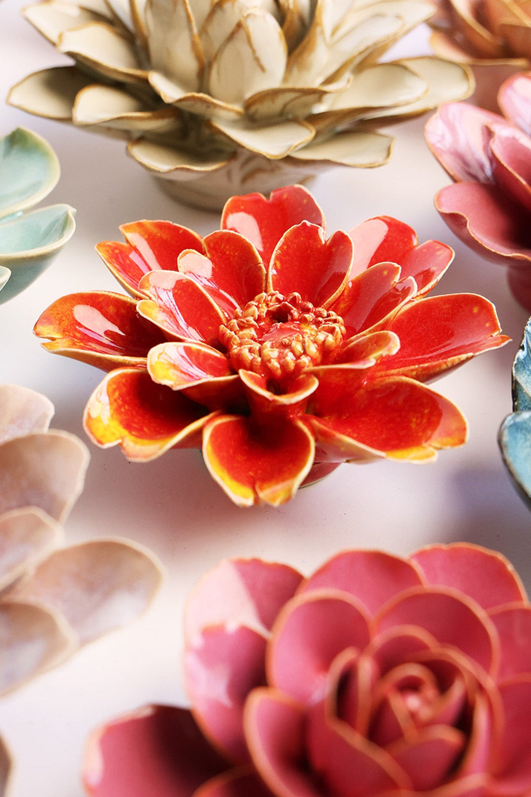Yellow Daisy ceramic wall flower styled on a white table with other flowers — Chive Studio