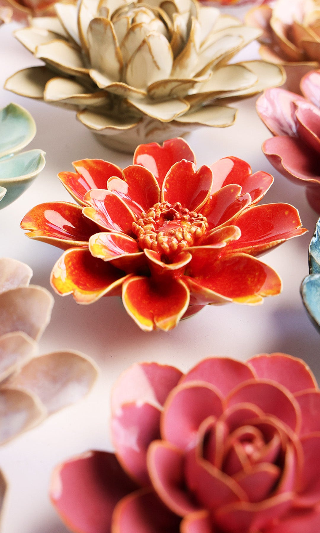 Yellow Daisy ceramic wall flower styled on a white table with other flowers — Chive Studio