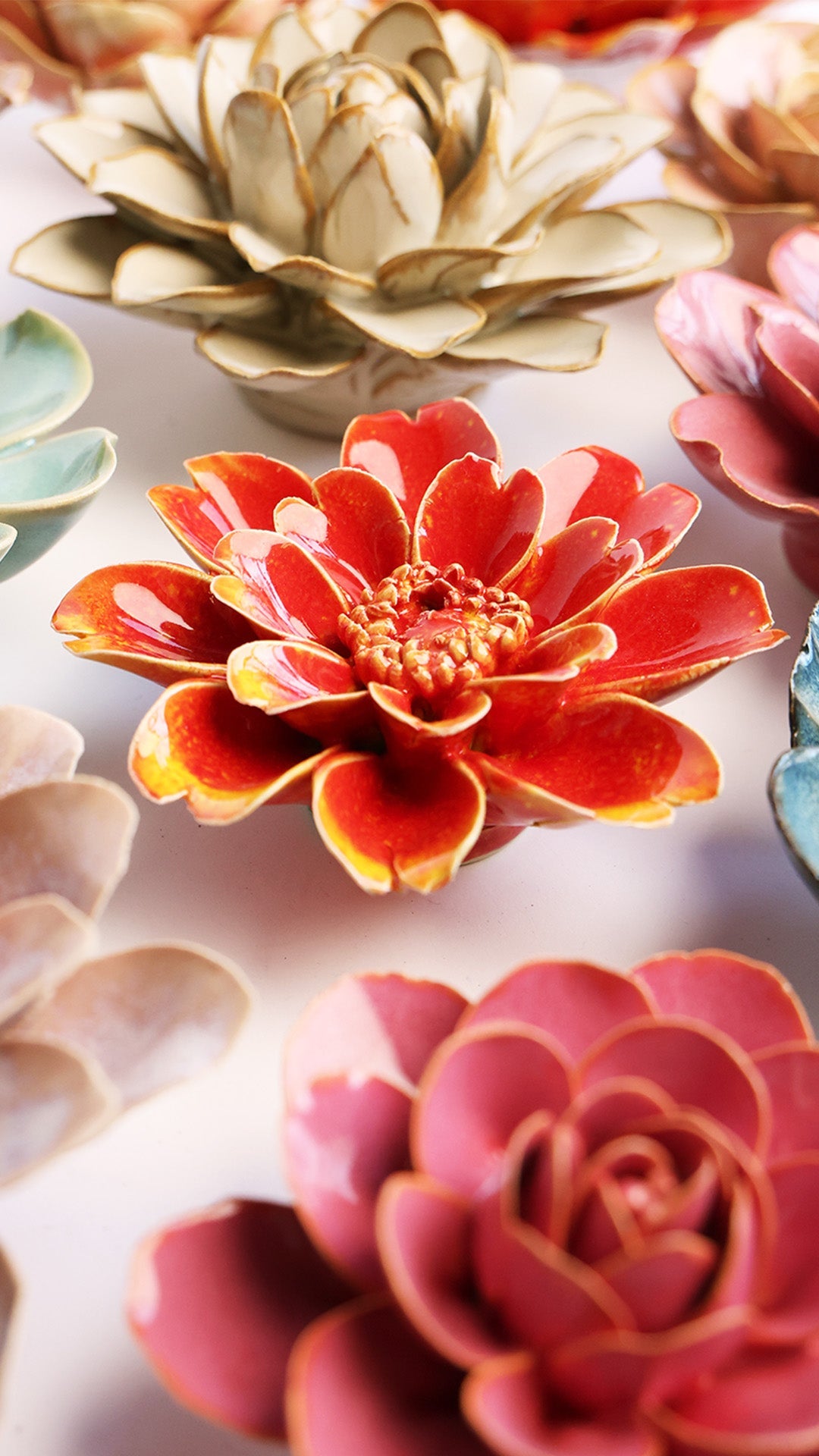 Yellow Daisy ceramic wall flower styled on a white table with other flowers — Chive Studio