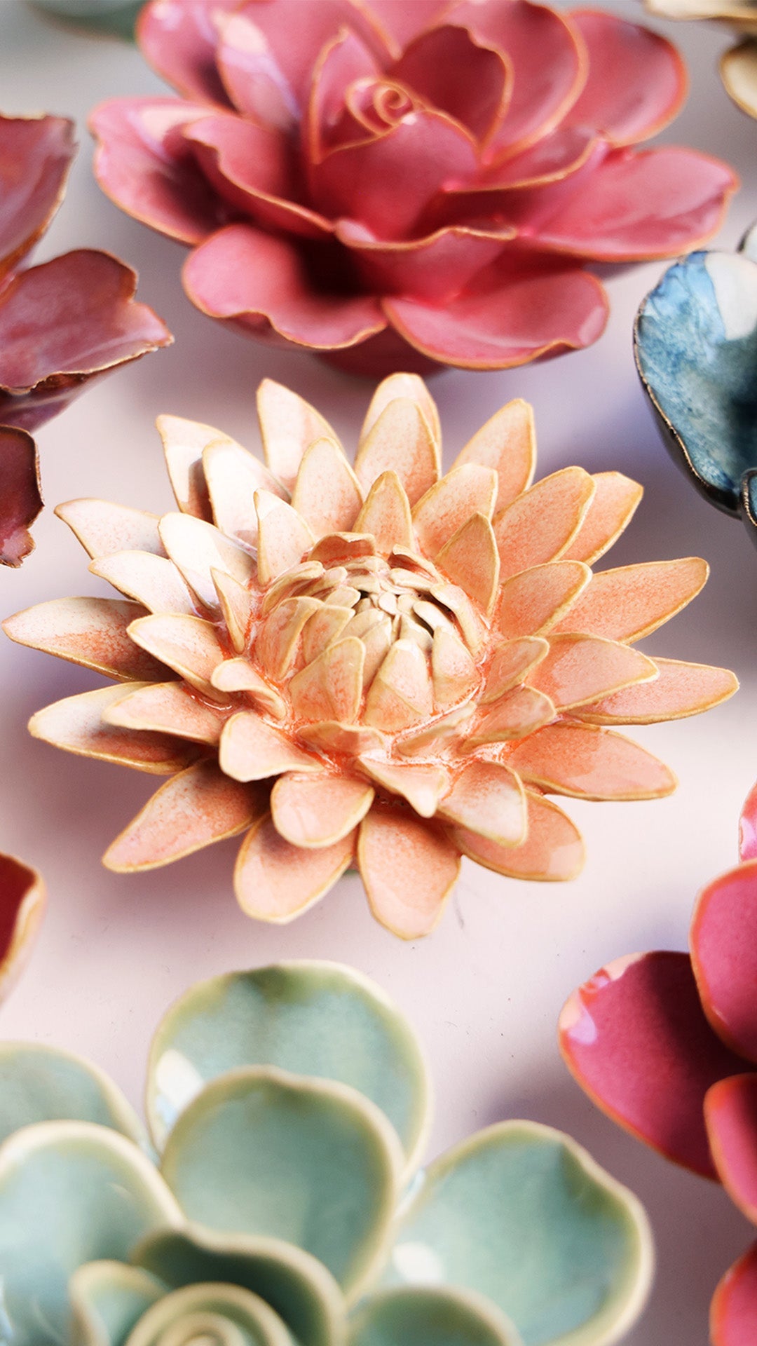 Peach Pink Strawflower ceramic wall flower styled on a white table with other flowers — Chive Studio