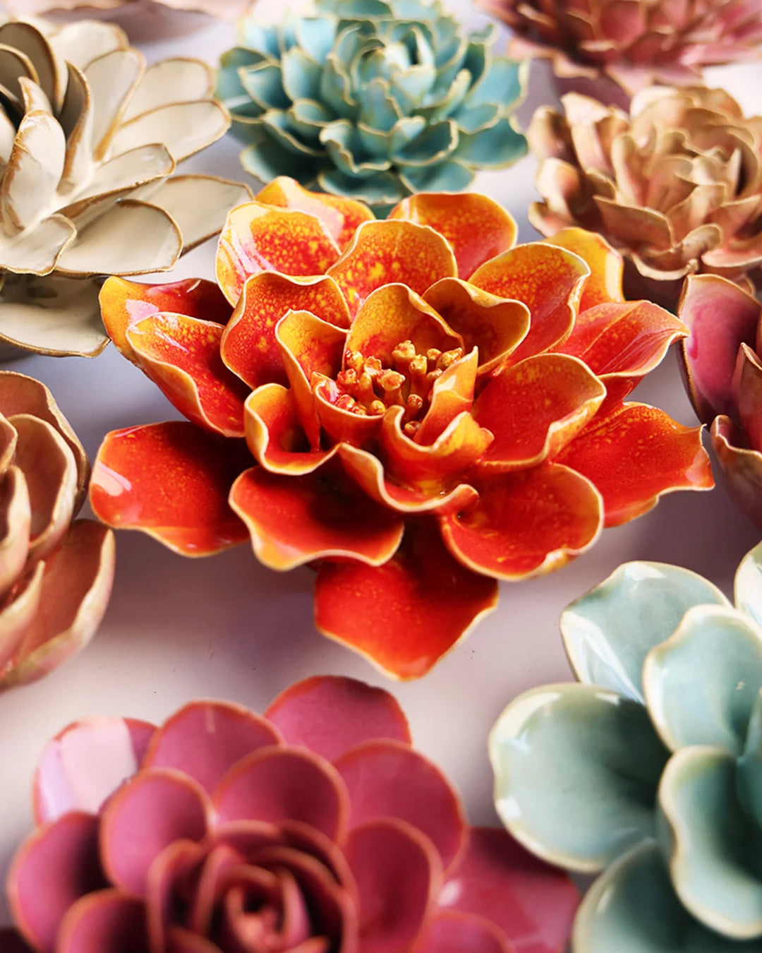 Orange Yellow Coreopsis ceramic wall flower mounted on a wall — Chive Ceramics Studio