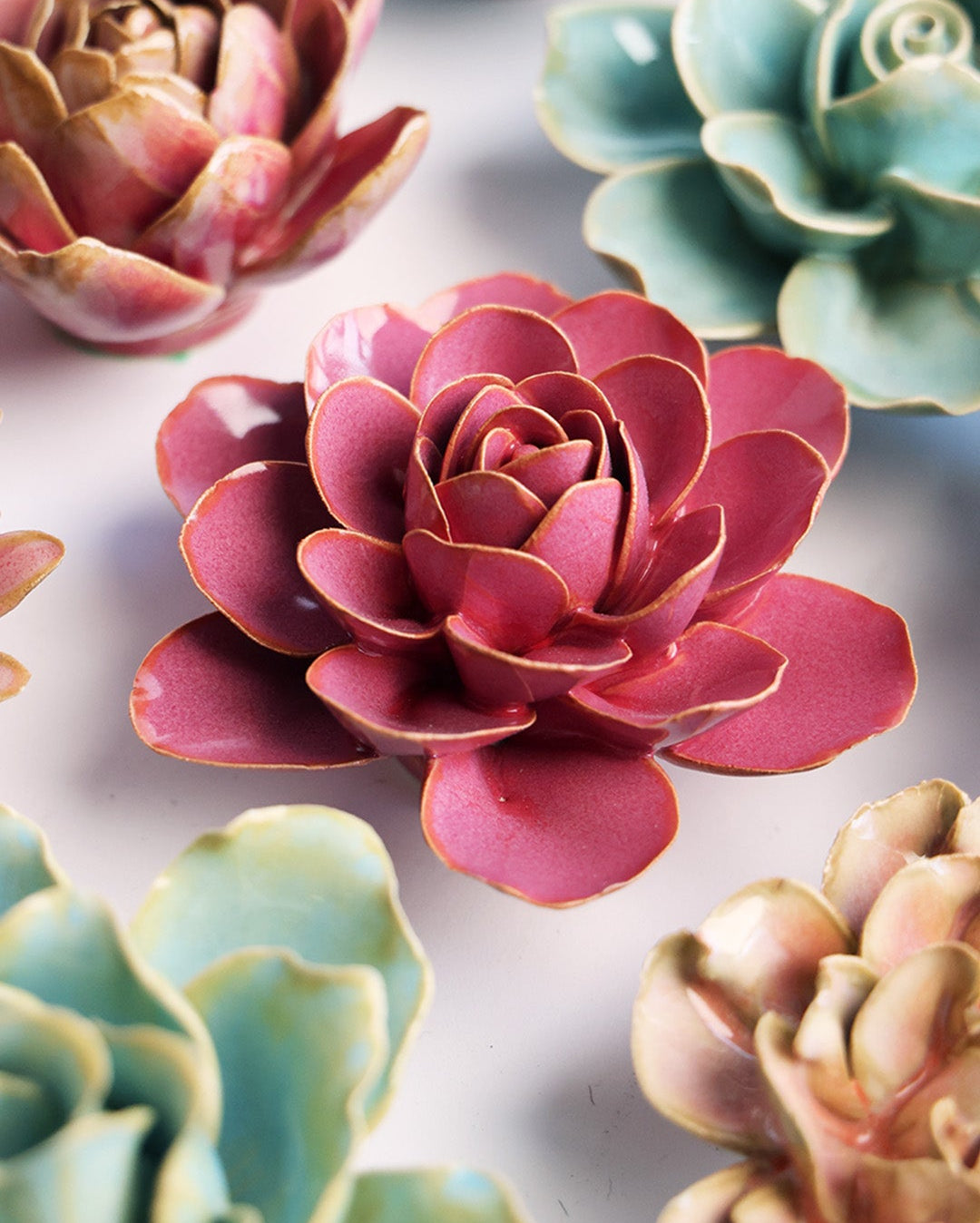 Blush Pink Begonia ceramic wall flower mounted on a wall — Chive Ceramics Studio