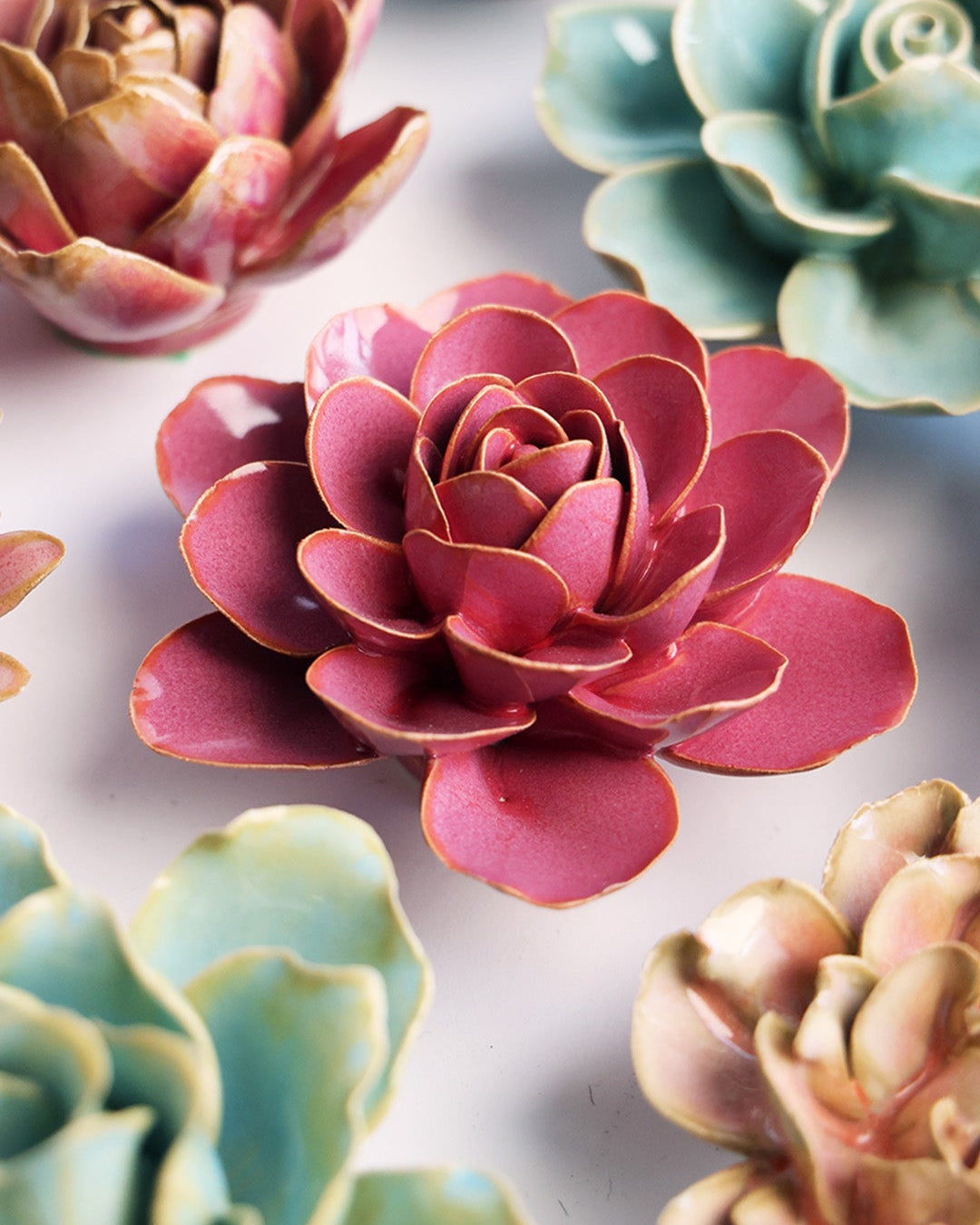 Blush Pink Begonia ceramic wall flower mounted on a wall — Chive Ceramics Studio
