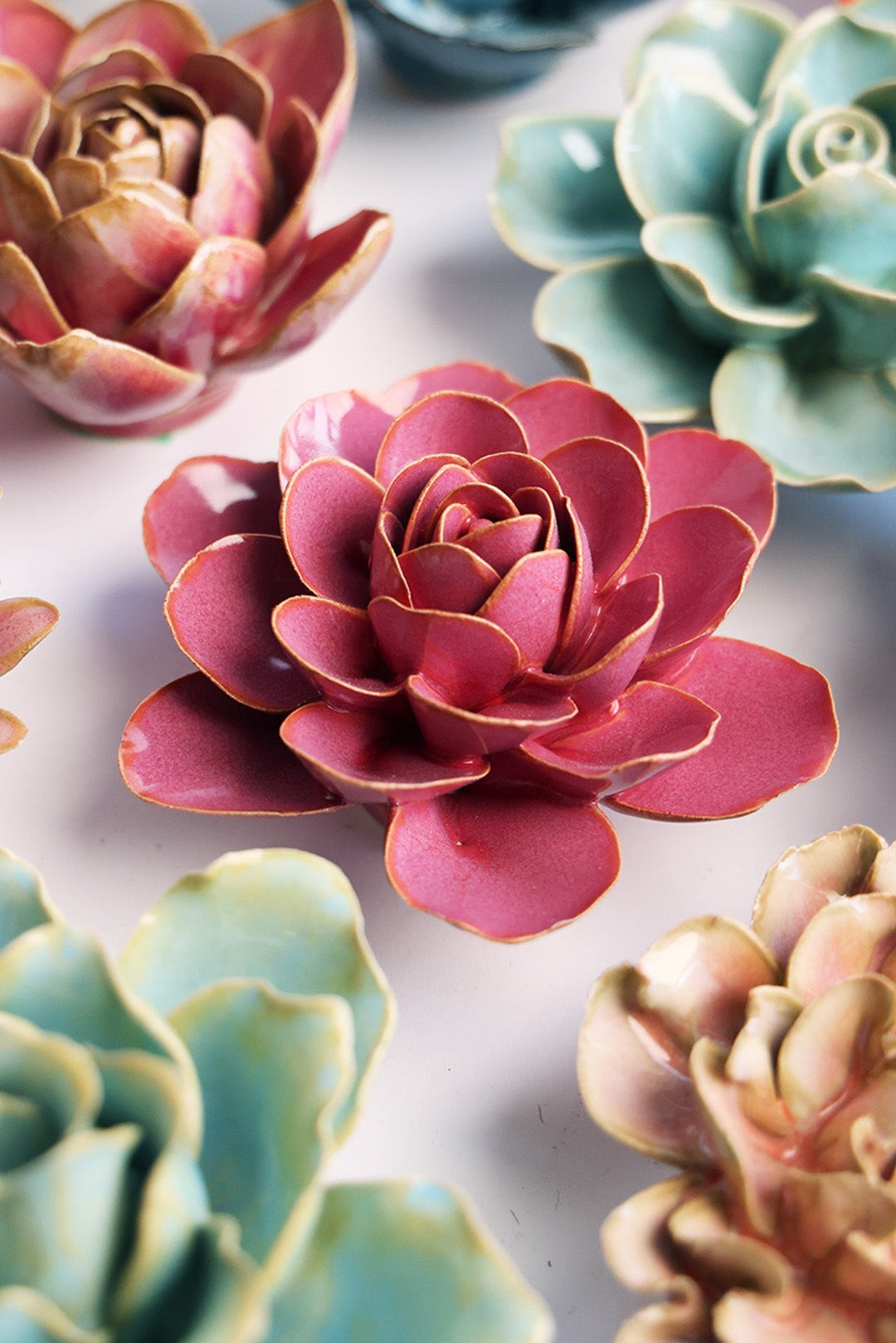 Blush Pink Begonia ceramic wall flower styled on a white table with other flowers — Chive Studio